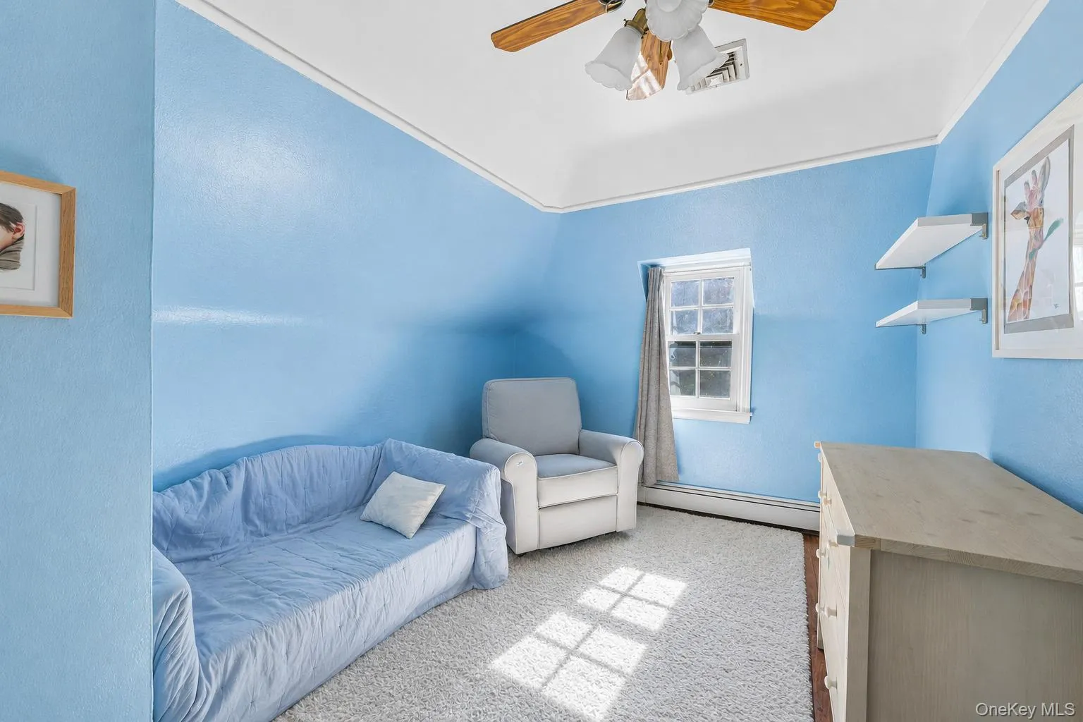 Bedroom featuring wood-finish flooring and a ceiling fan with integrated lighting Bedroom featuring wood-finish flooring and a ceiling fan with integrated lighting