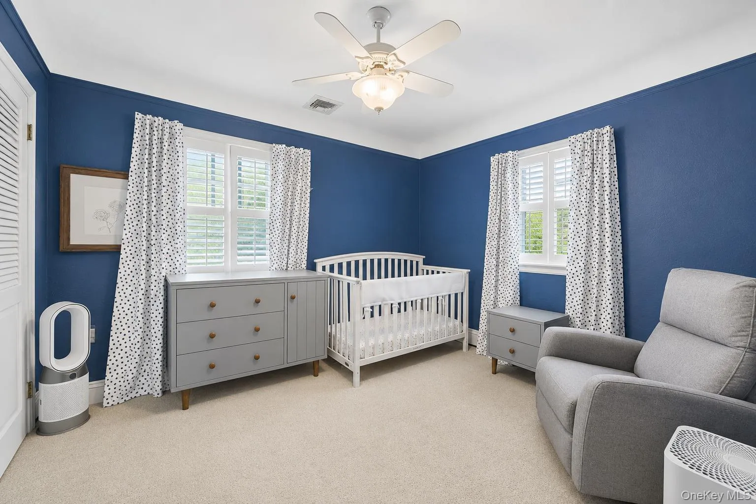 Bedroom featuring carpeted flooring and walls with a blue finish Bedroom featuring carpeted flooring and walls with a blue finish