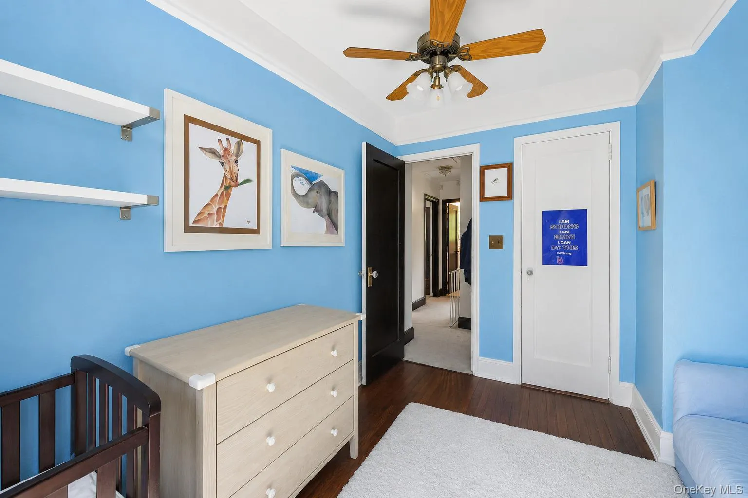 Bedroom featuring wood-finish flooring and a ceiling fan with integrated lighting Bedroom featuring wood-finish flooring and a ceiling fan with integrated lighting