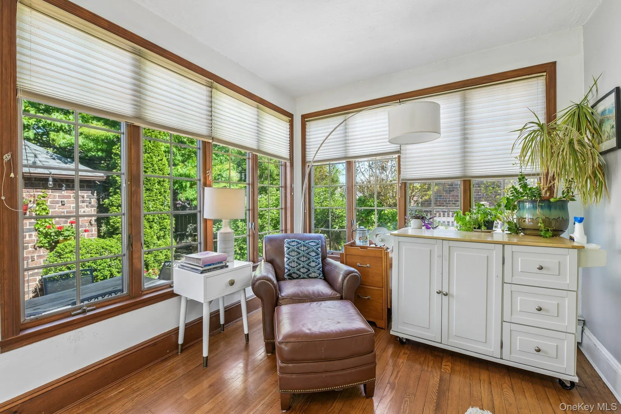 Hardwood flooring extends throughout this room, featuring ample natural light from multiple windows Hardwood flooring extends throughout this room, featuring ample natural light from multiple windows