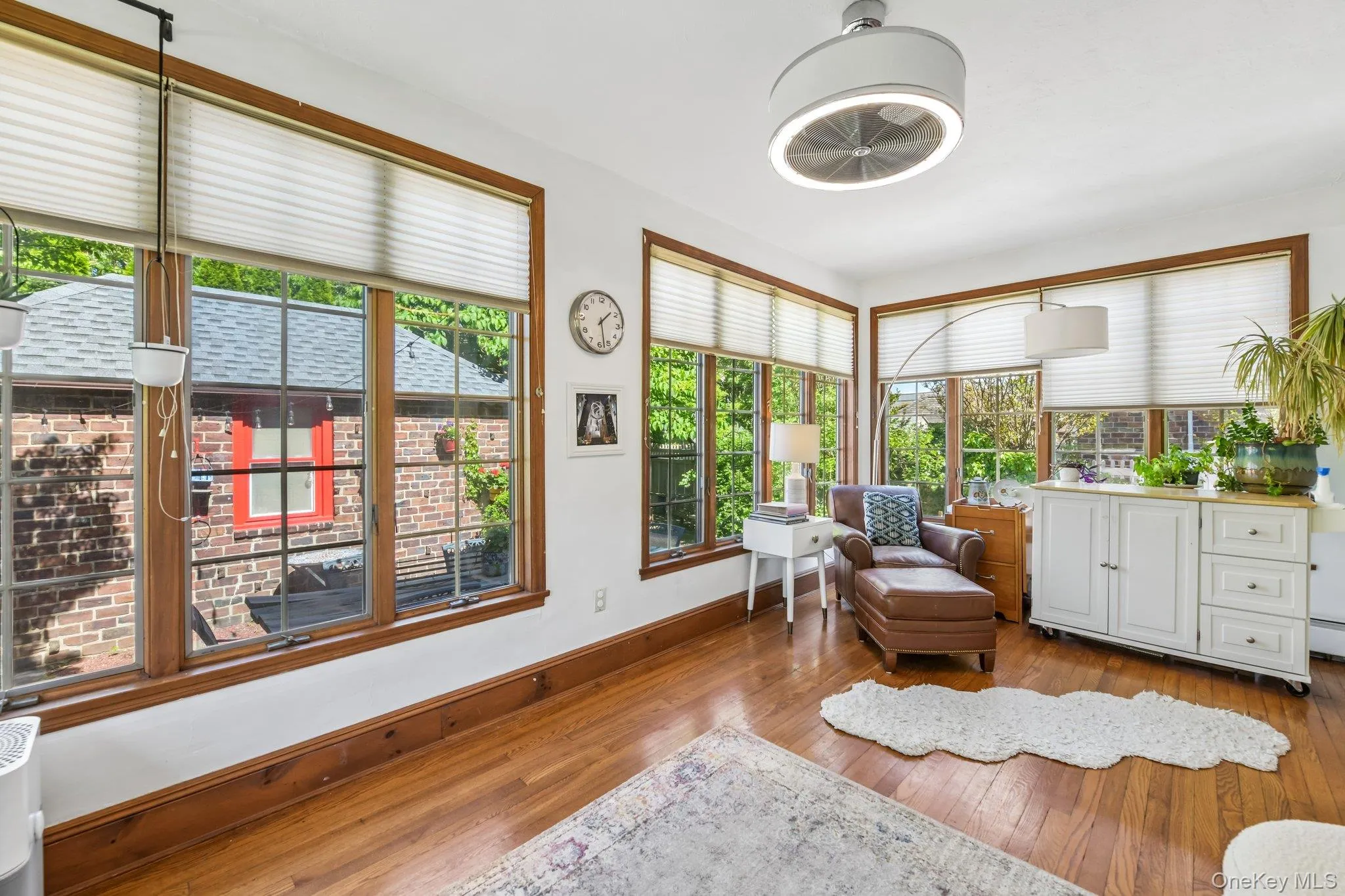 Hardwood flooring extends throughout this room, featuring ample natural light from multiple windows Hardwood flooring extends throughout this room, featuring ample natural light from multiple windows