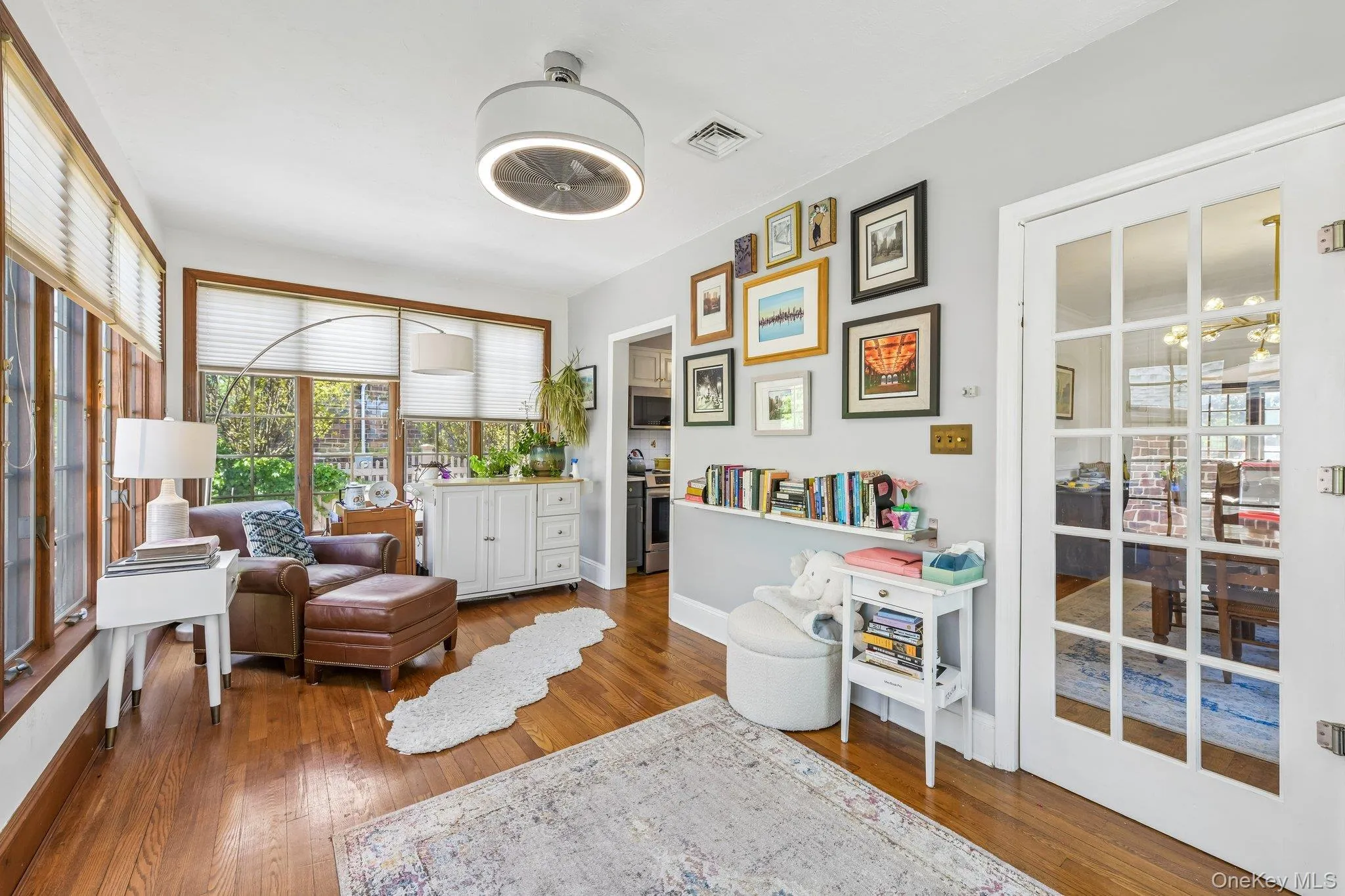 Hardwood flooring extends throughout this room, featuring ample natural light from multiple windows Hardwood flooring extends throughout this room, featuring ample natural light from multiple windows