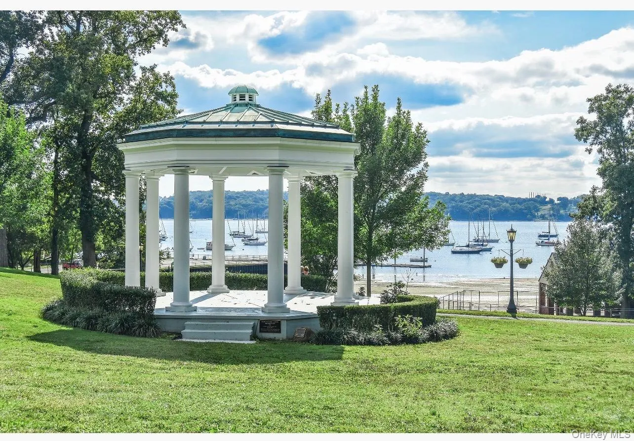 Renowned Morgan's Park, exclusive park for Glen cove Residents .Classic white gazebo featuring a domed roof and column supports, set on a manicured lawn Renowned Morgan's Park, exclusive park for Glen cove Residents .Classic white gazebo featuring a domed roof and column supports, set on a manicured lawn