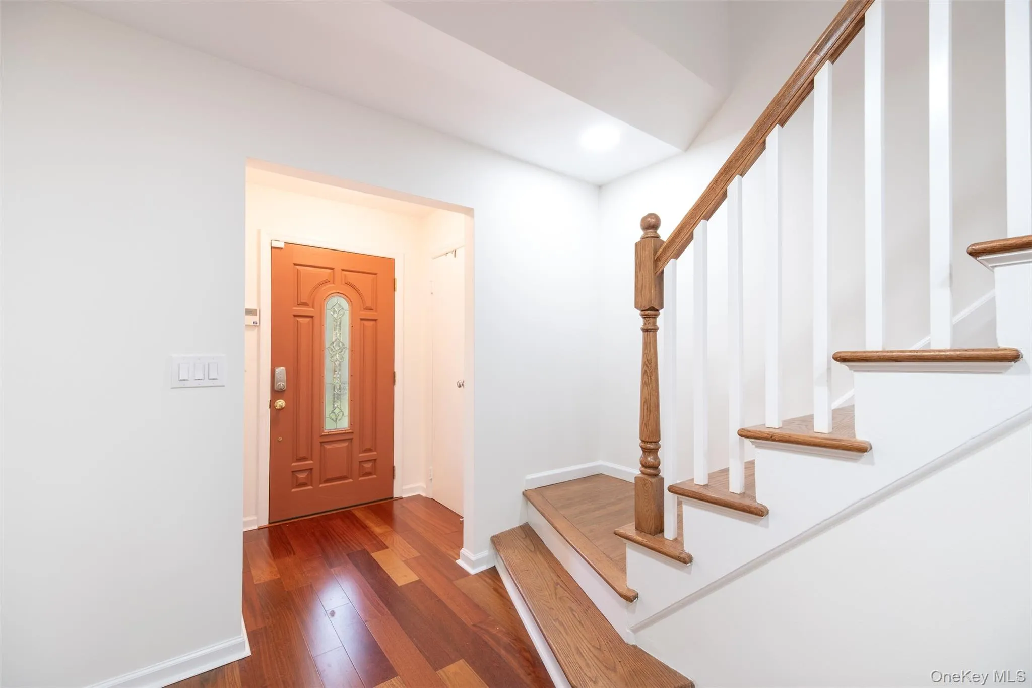 Entryway with stairway, dark wood-style floors, baseboards, and recessed lighting Entryway with stairway, dark wood-style floors, baseboards, and recessed lighting