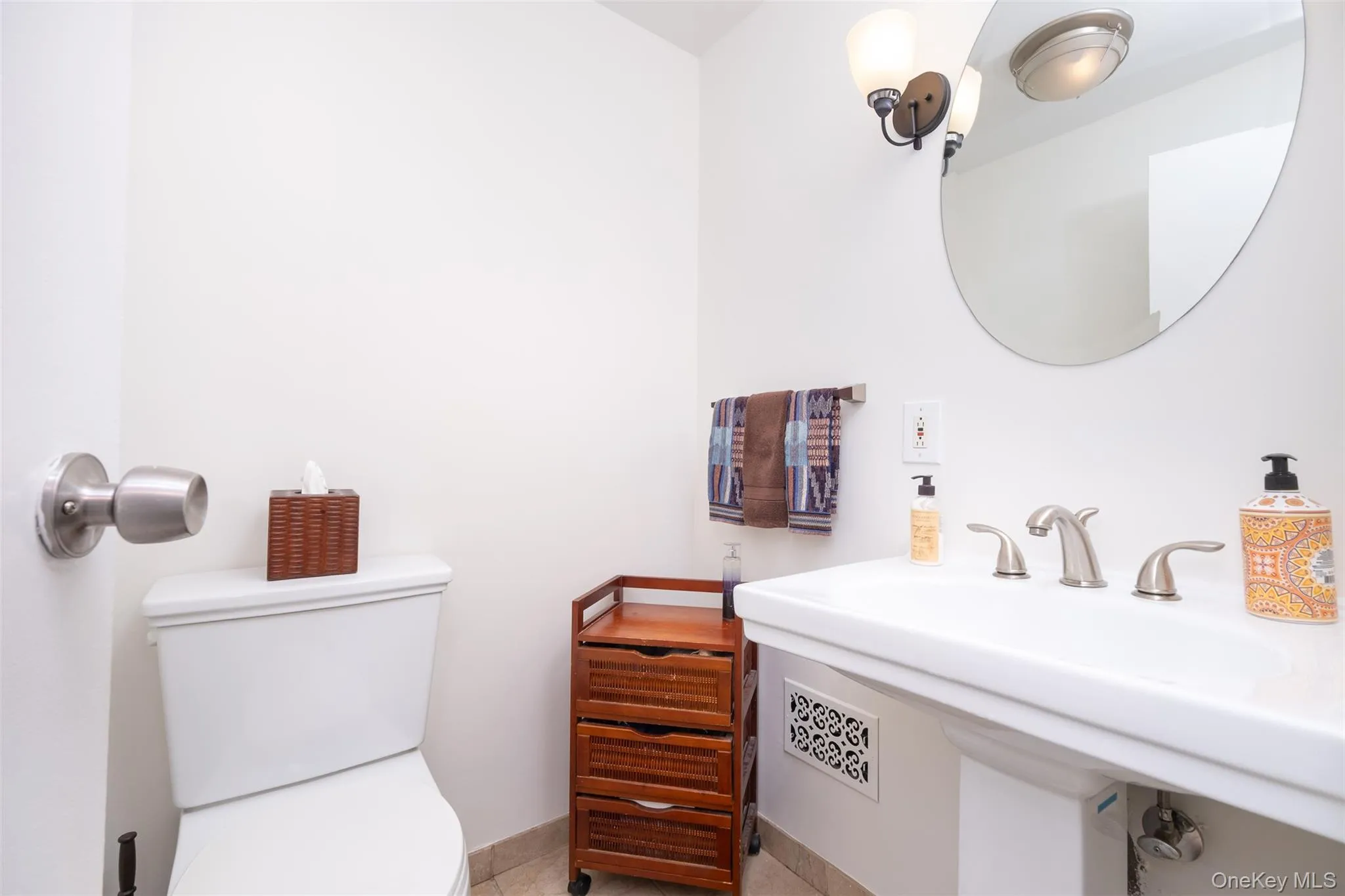 Half bathroom featuring toilet and a sink Half bathroom featuring toilet and a sink