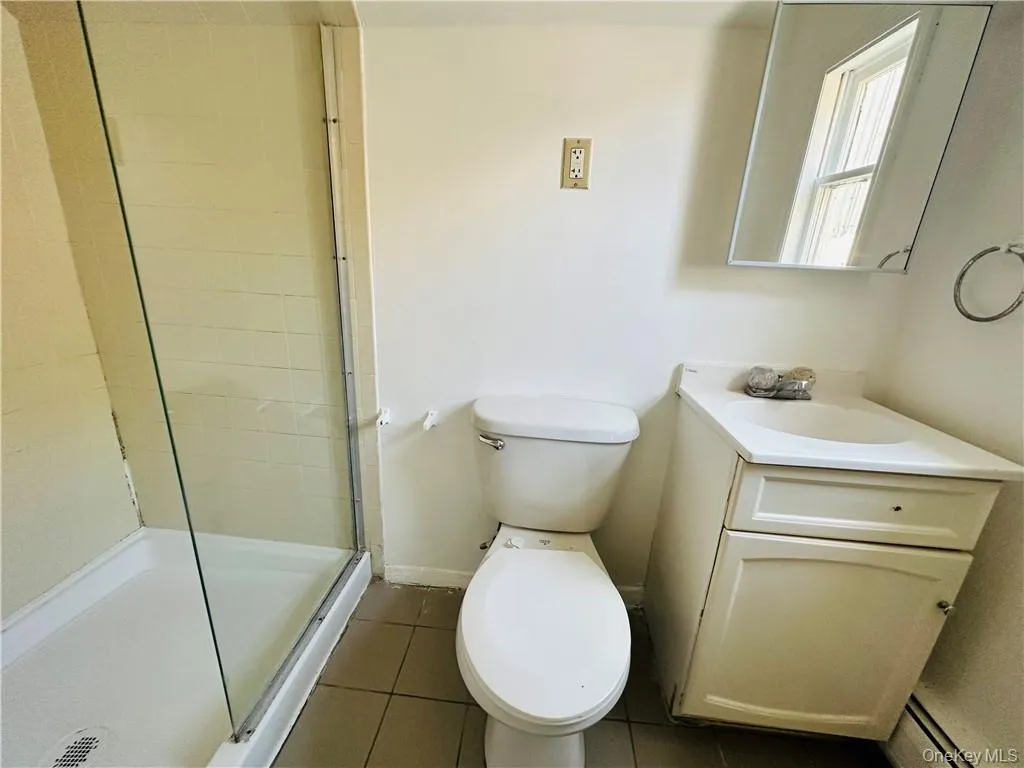 Full Hallway Bathroom 2 with tile floors, walk in shower, toilet, and vanity Full Hallway Bathroom 2 with tile floors, walk in shower, toilet, and vanity