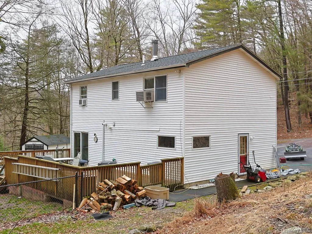 Back of property with roof with shingles and a deck Back of property with roof with shingles and a deck