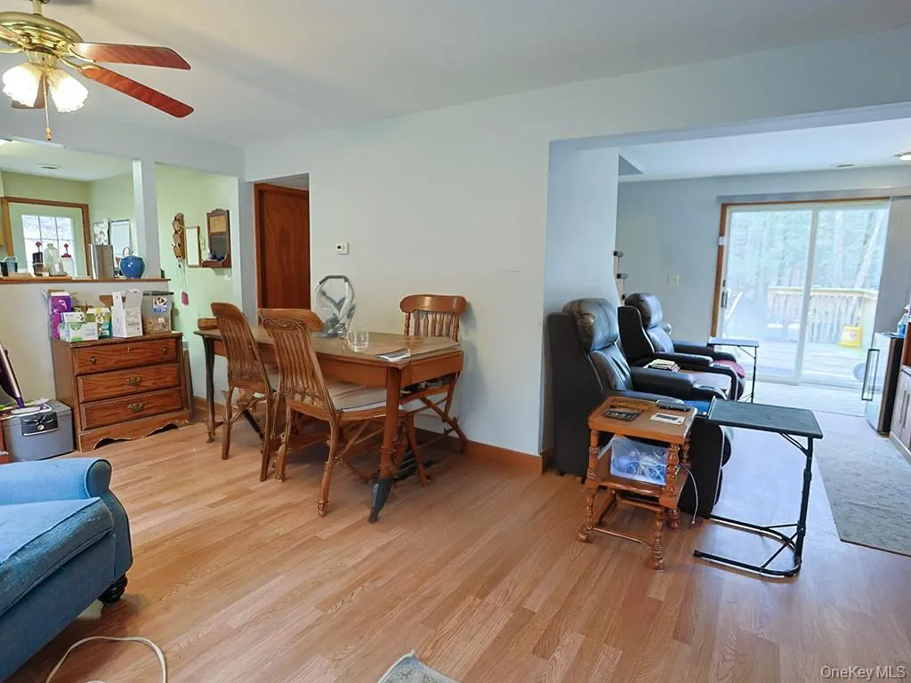 living room flooring, ceiling fan, and baseboards living room flooring, ceiling fan, and baseboards