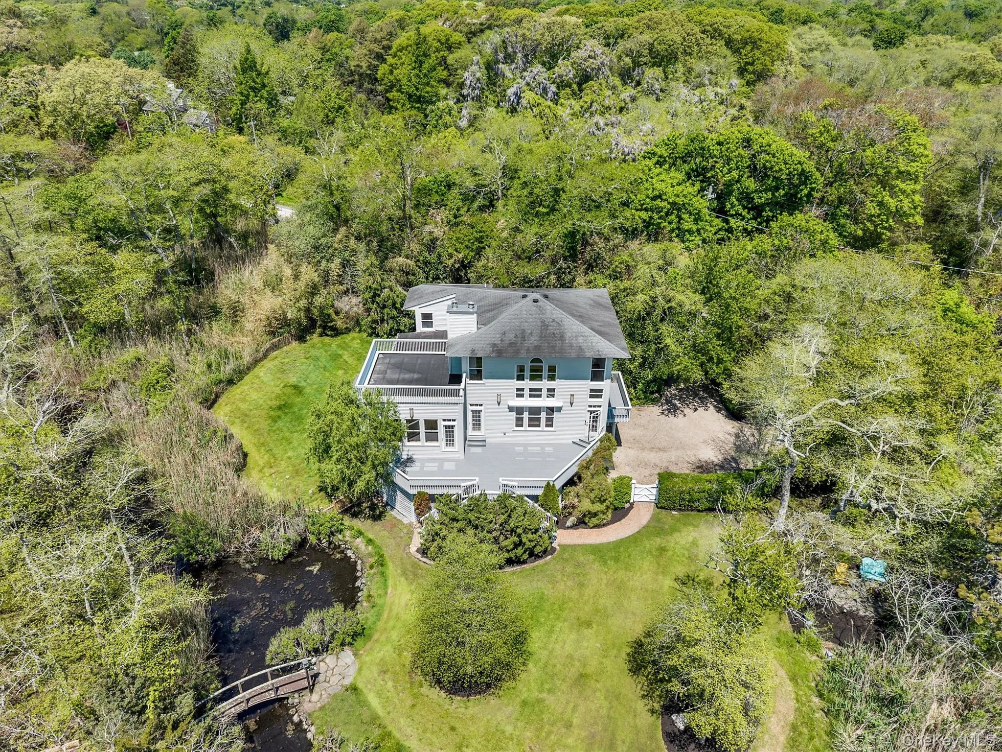 Contemporary multi-level residence featuring multiple balconies and a gravel driveway Contemporary multi-level residence featuring multiple balconies and a gravel driveway
