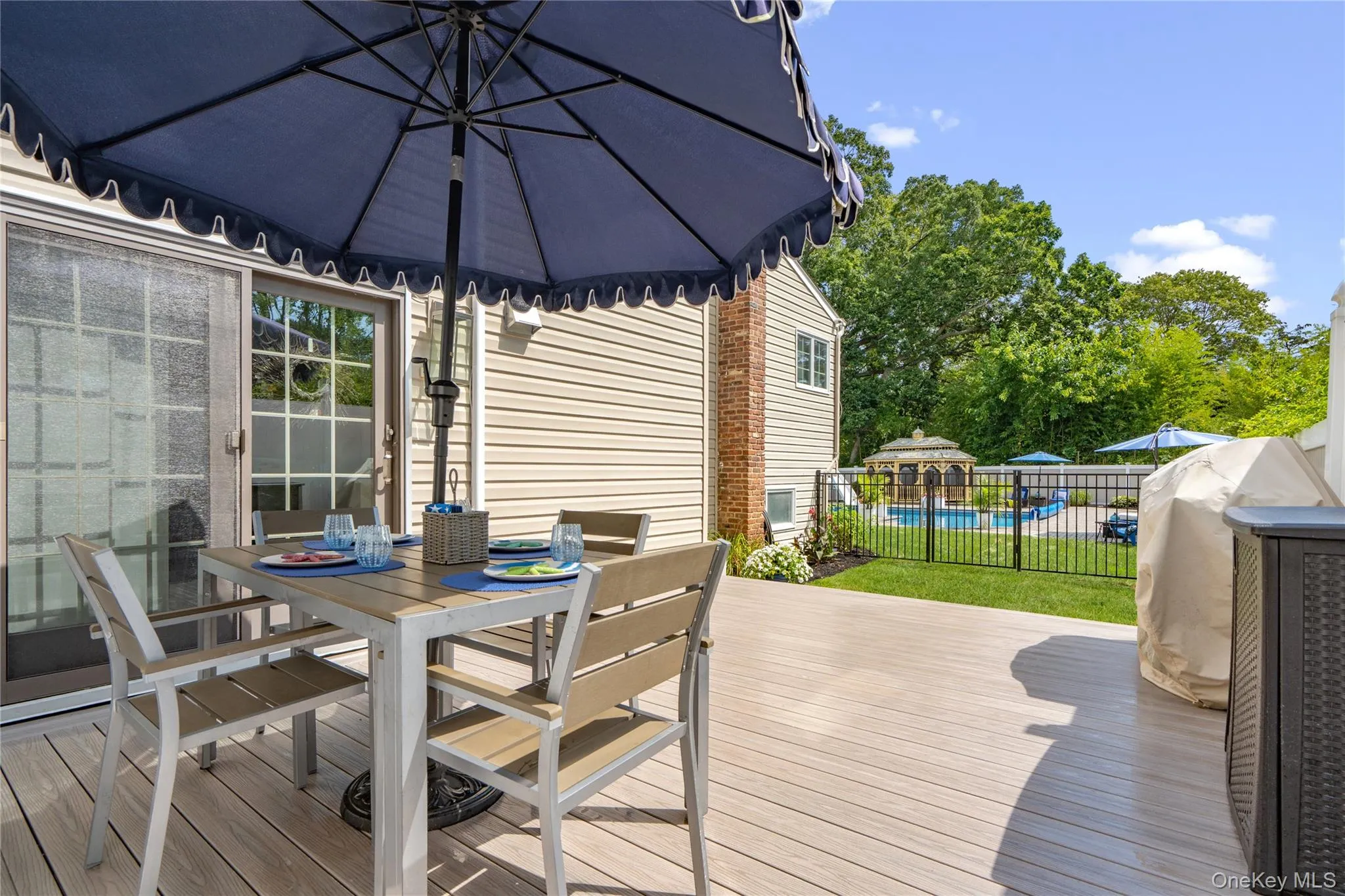 Expansive composite deck featuring a direct entry sliding glass door Expansive composite deck featuring a direct entry sliding glass door
