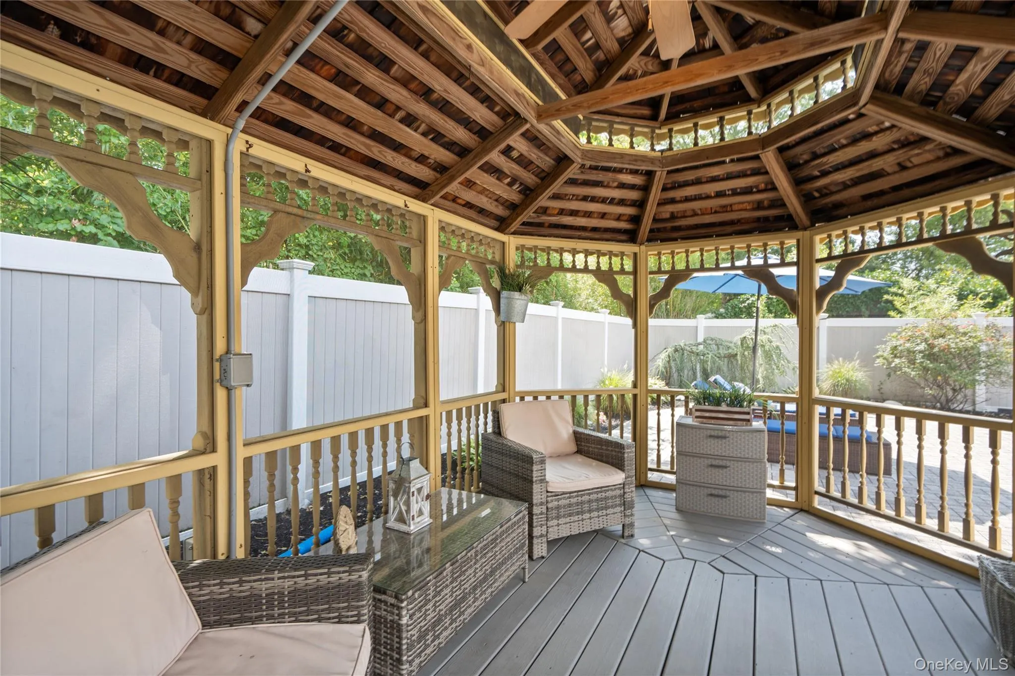Octagonal wooden gazebo featuring a slatted wood roof, decorative balustrades, and wood-finish flooring, electric Octagonal wooden gazebo featuring a slatted wood roof, decorative balustrades, and wood-finish flooring, electric
