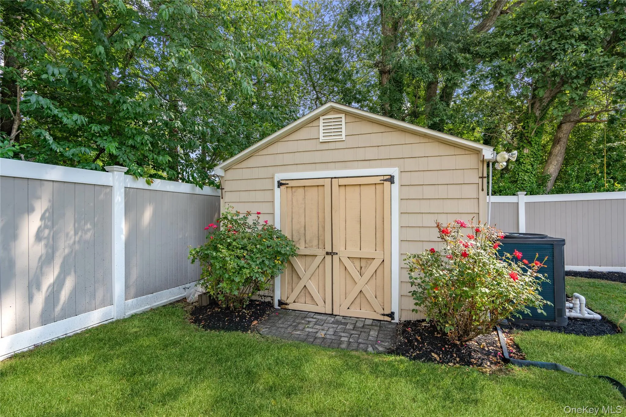 Garden shed with barn-style doors, shingle siding, and a gabled roof Garden shed with barn-style doors, shingle siding, and a gabled roof