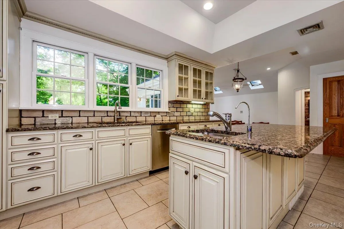 Granite counters, tile floors, Cambridge cabinets, inset ss sink with windows overlooking the yard Granite counters, tile floors, Cambridge cabinets, inset ss sink with windows overlooking the yard