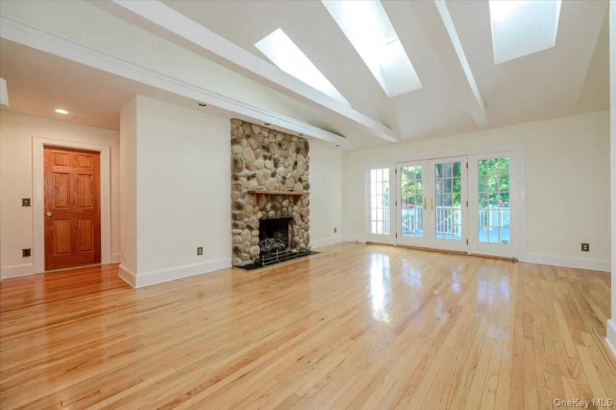 A great space, the living room is drenched in natural light, vaulted ceiling w/beams, gas fireplace, skylights and French doors to deck A great space, the living room is drenched in natural light, vaulted ceiling w/beams, gas fireplace, skylights and French doors to deck