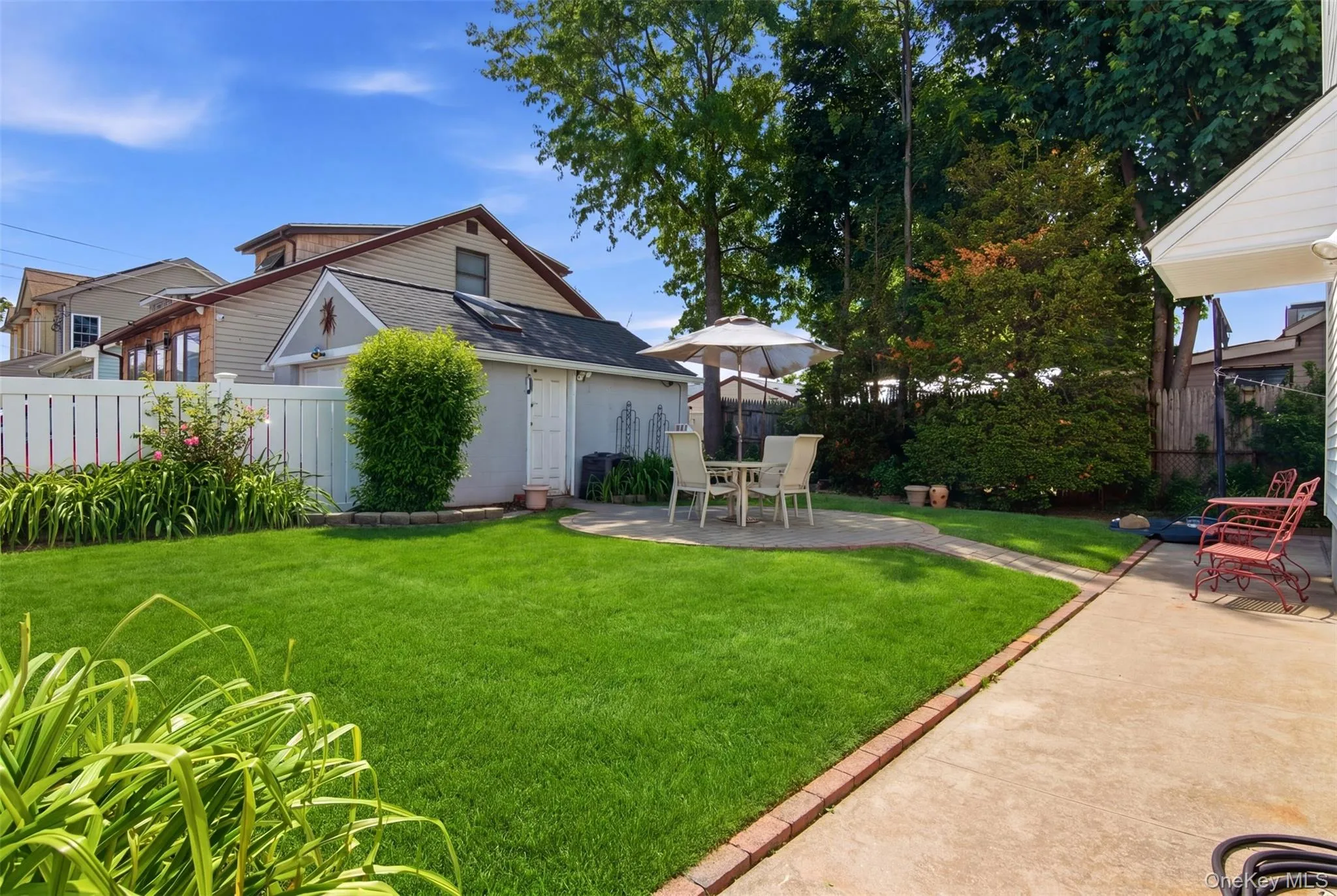 Beautifully backyard with garage leading into house and circular brick area for patio dining. Beautifully backyard with garage leading into house and circular brick area for patio dining.