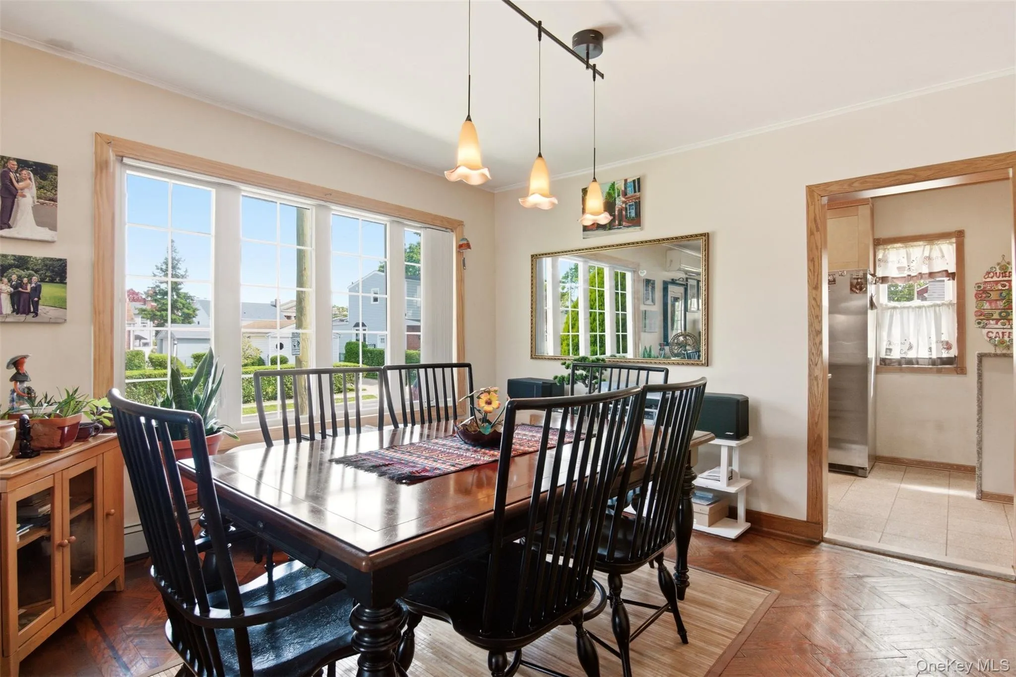 Formal dining room with windows and hanging ceiling lights. Formal dining room with windows and hanging ceiling lights.