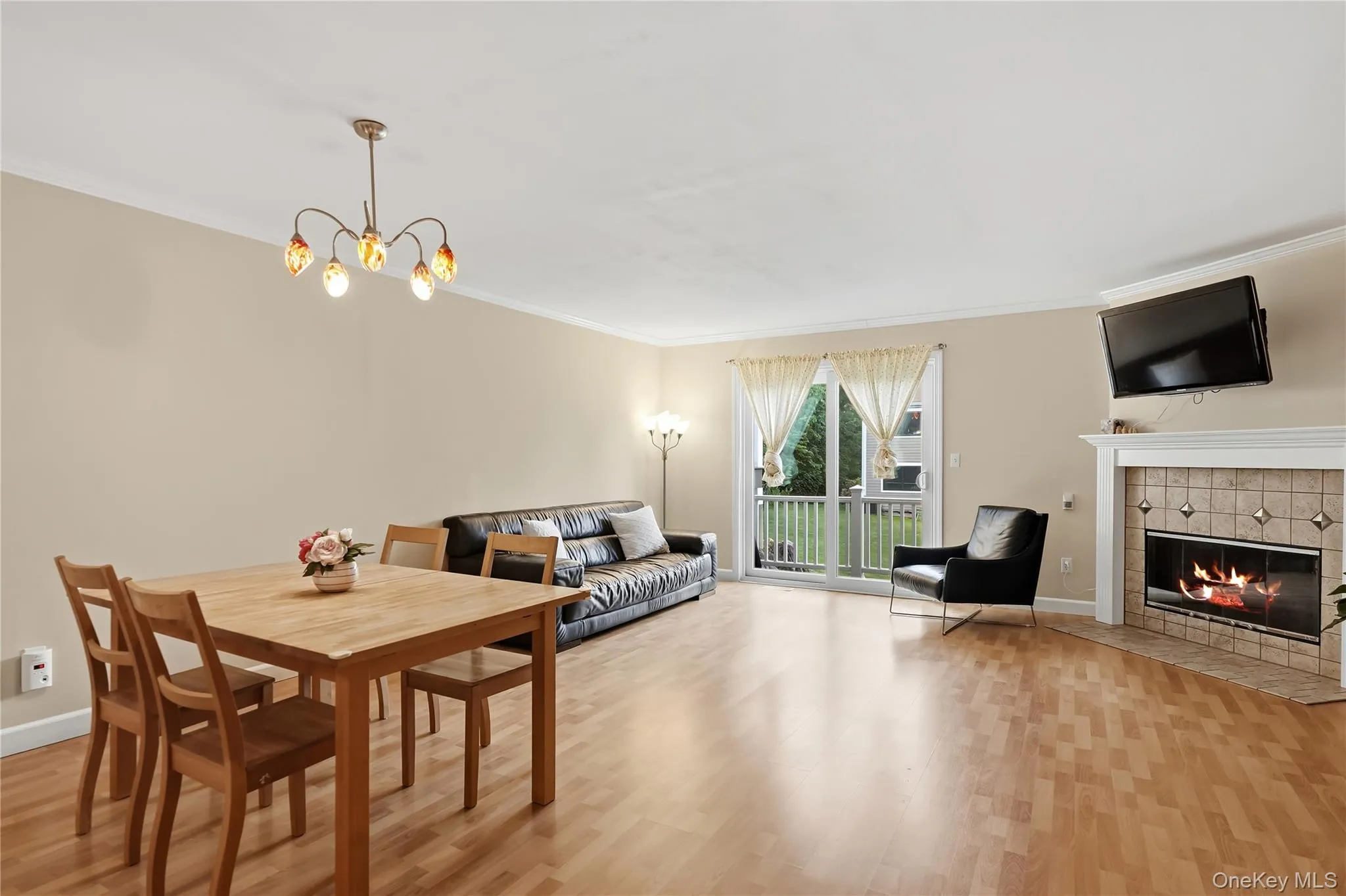 Living roon with wood burning fireplace, crown molding and deck access Living roon with wood burning fireplace, crown molding and deck access