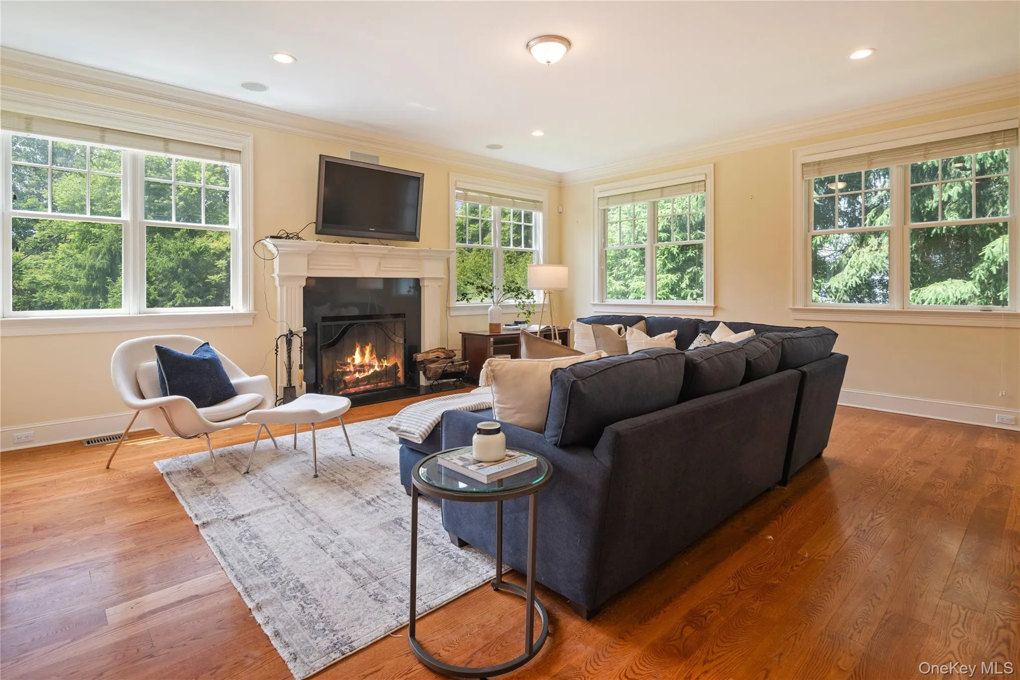 Family room with wood burning fireplace, flat screen tv hookup, crown molding, recessed lighting, wide board oak floors Family room with wood burning fireplace, flat screen tv hookup, crown molding, recessed lighting, wide board oak floors