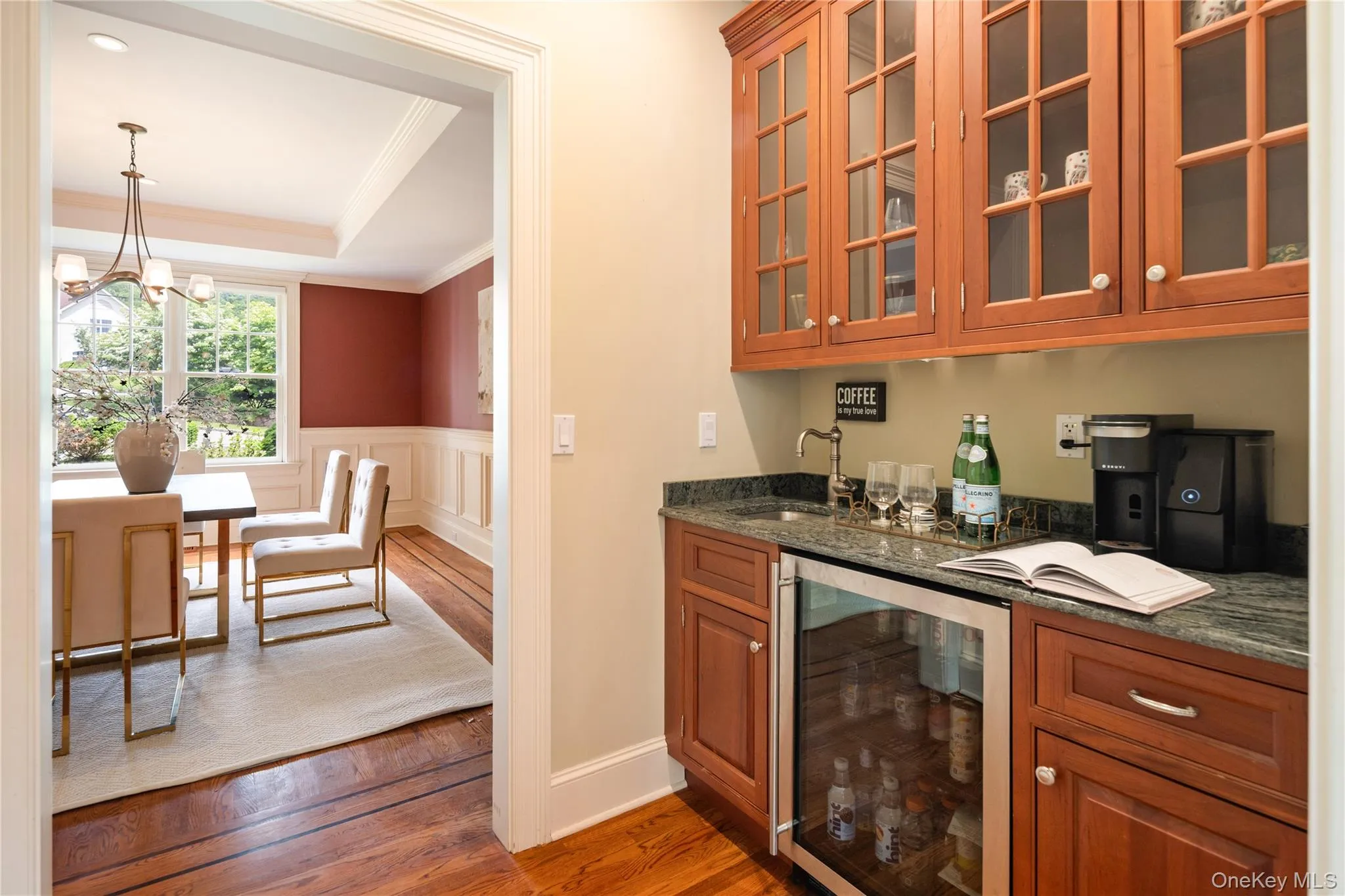 Butlers pantry with prep sink, granite counters, glazed display cabinetry, wine refrigerator Butlers pantry with prep sink, granite counters, glazed display cabinetry, wine refrigerator