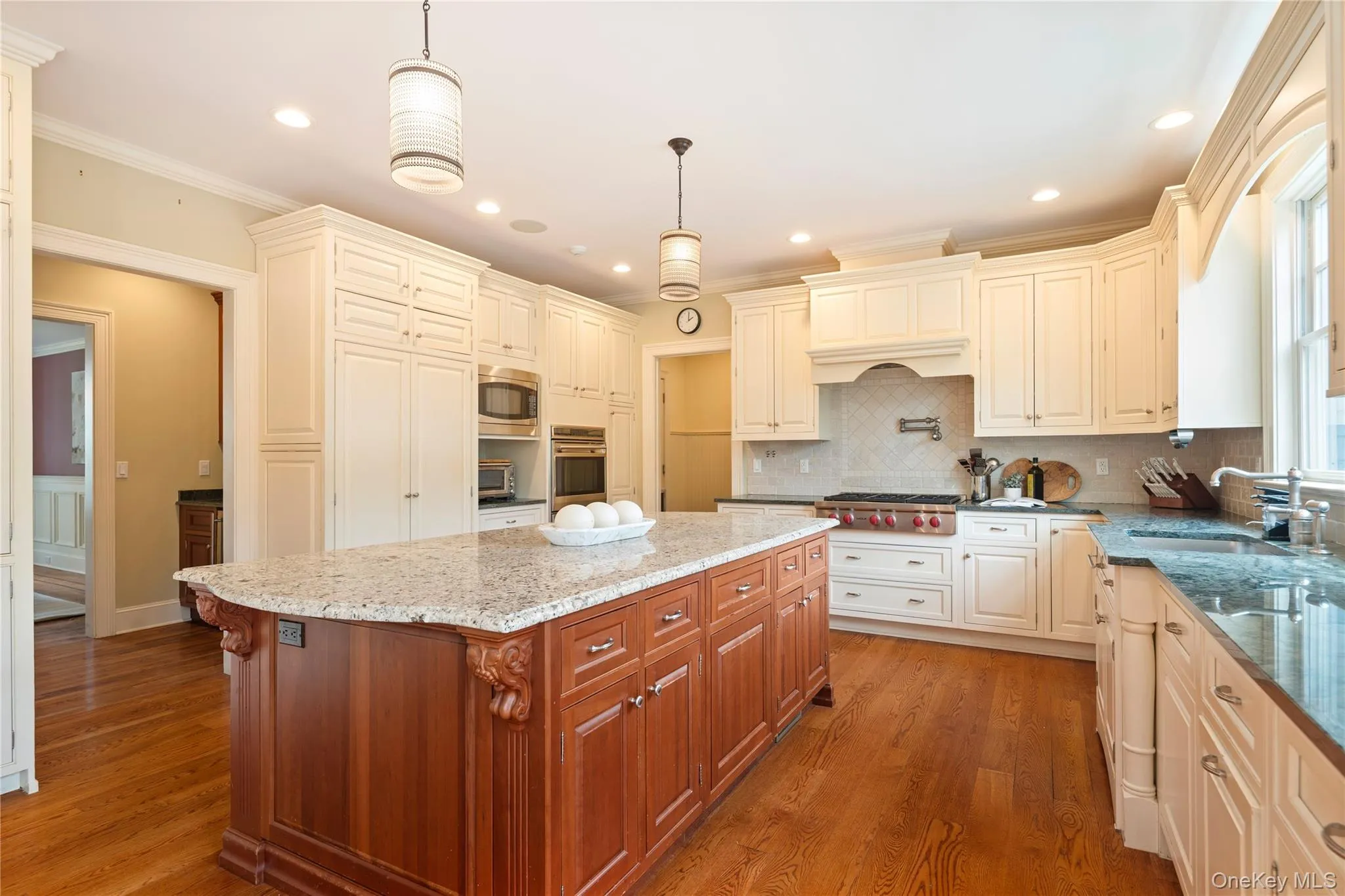 Kitchen with custom soft close cabinetry, large center island with seating and granite counters, Subzero with integral door panels, tumbled marble backsplash, Wolf stainless steel gas 6 burner cooktop, pot filler above, Wolf stainless steel double convection wall ovens, built-in microwave, 2 Bosch dishwashers with integral door panels, recessed LED lighting, wide board oak floors, pendant lighting, large window overlooking back yard, door to butlers pantry, mud room Kitchen with custom soft close cabinetry, large center island with seating and granite counters, Subzero with integral door panels, tumbled marble backsplash, Wolf stainless steel gas 6 burner cooktop, pot filler above, Wolf stainless steel double convection wall ovens, built-in microwave, 2 Bosch dishwashers with integral door panels, recessed LED lighting, wide board oak floors, pendant lighting, large window overlooking back yard, door to butlers pantry, mud room
