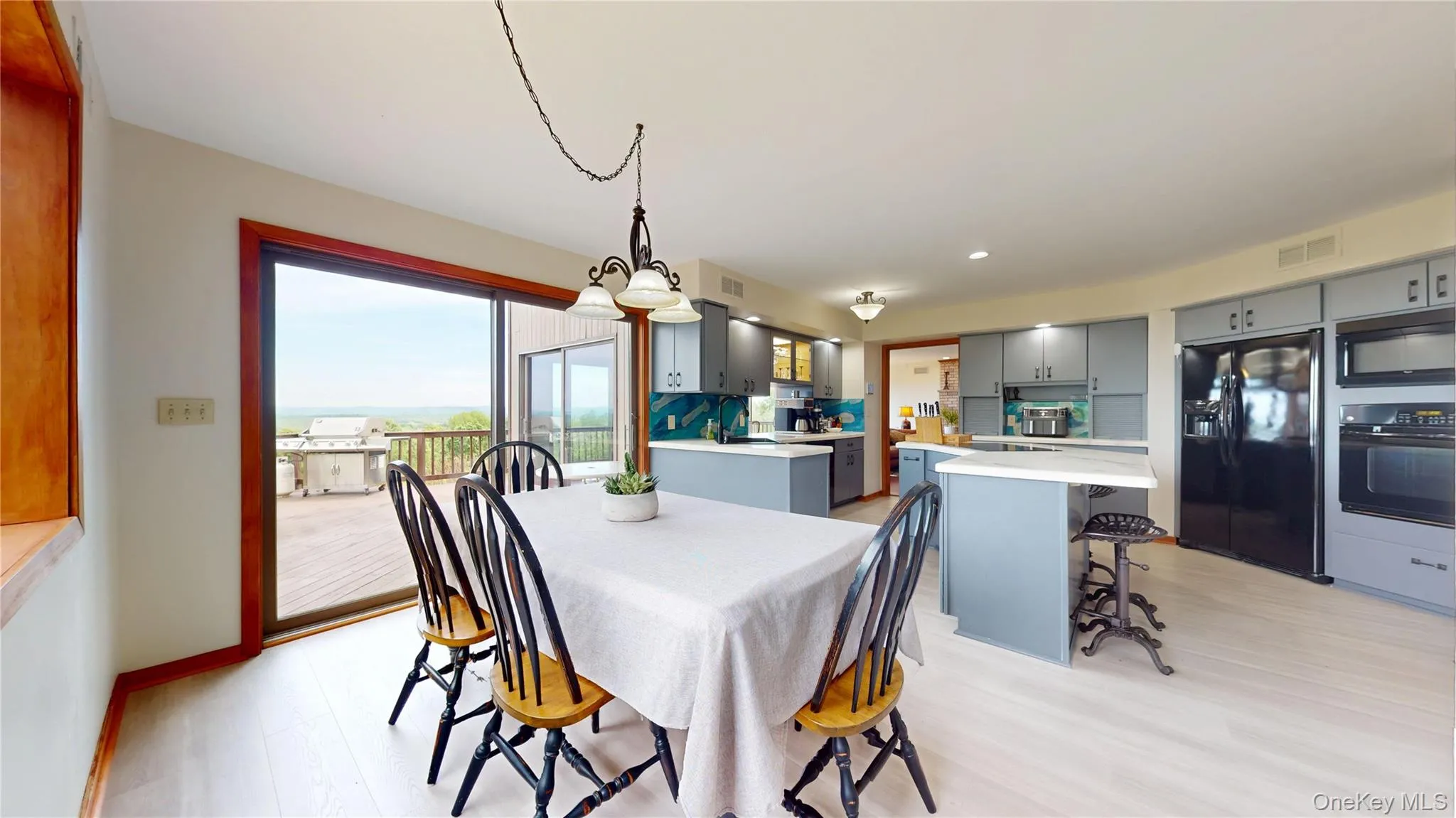 Open-concept kitchen and dining area featuring light wood-finish flooring Open-concept kitchen and dining area featuring light wood-finish flooring