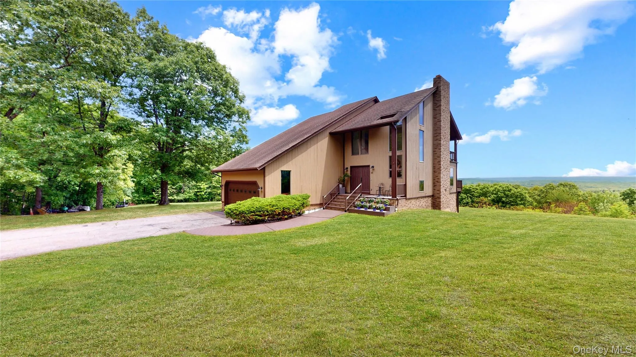 Contemporary-style residence with a prominent brick chimney and a multi-level roofline Contemporary-style residence with a prominent brick chimney and a multi-level roofline
