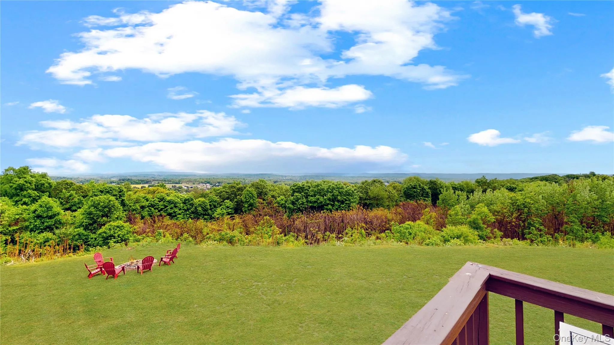 Expansive green lawn with distant tree-lined horizons Expansive green lawn with distant tree-lined horizons