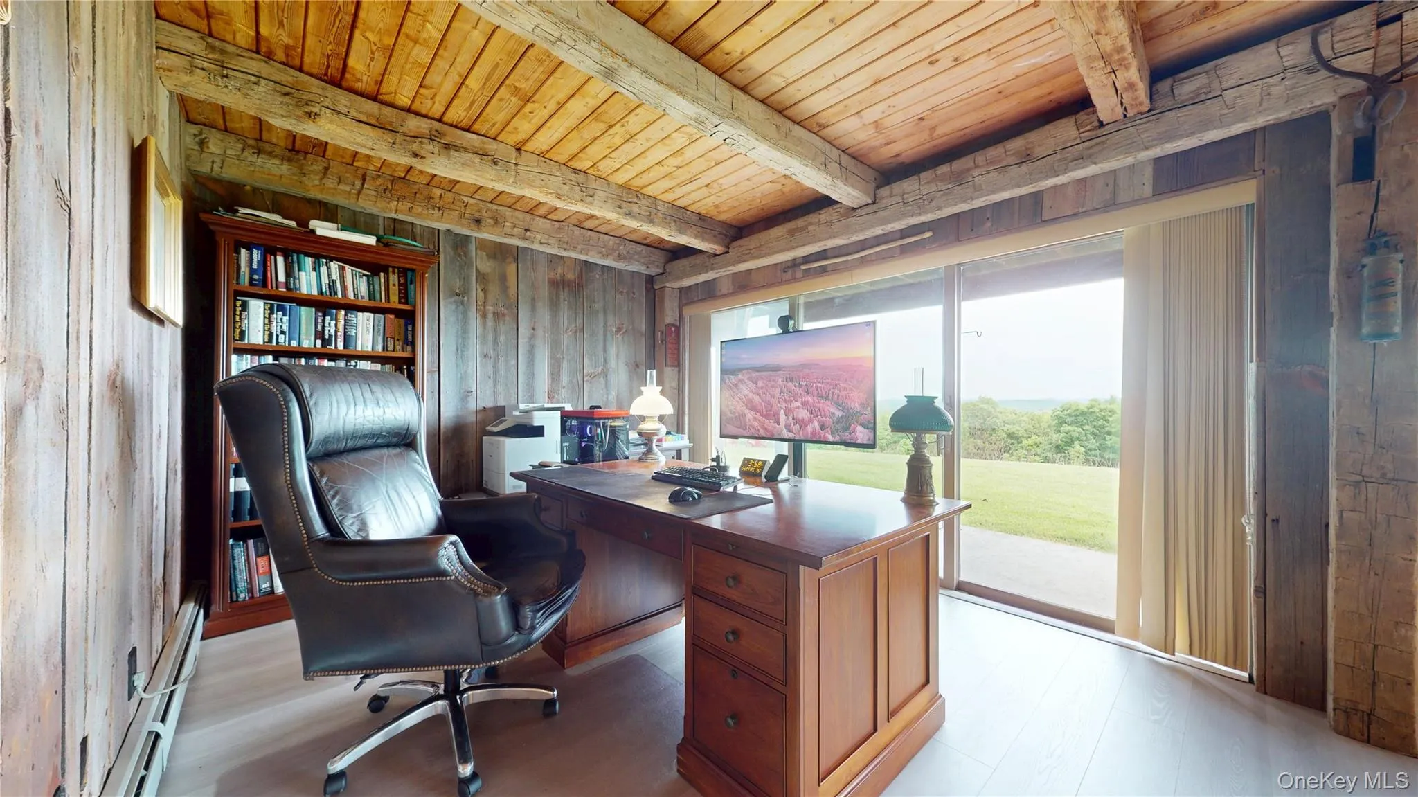 Wood paneling with exposed ceiling beams and light wood-finish flooring Wood paneling with exposed ceiling beams and light wood-finish flooring