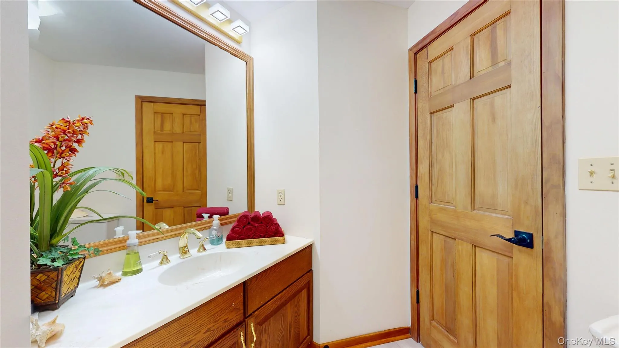 Bathroom vanity with a white countertop and an integrated sink Bathroom vanity with a white countertop and an integrated sink