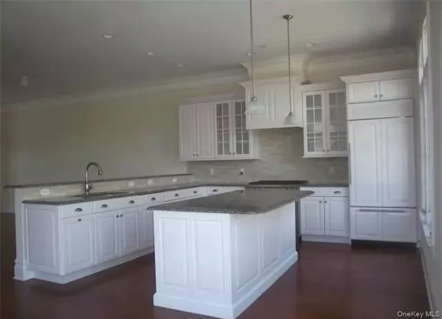 Large center island with breakfast counter... exhaust over Wolf gas cook top/oven combo... granite counters... custom tile back splashes... Large center island with breakfast counter... exhaust over Wolf gas cook top/oven combo... granite counters... custom tile back splashes...