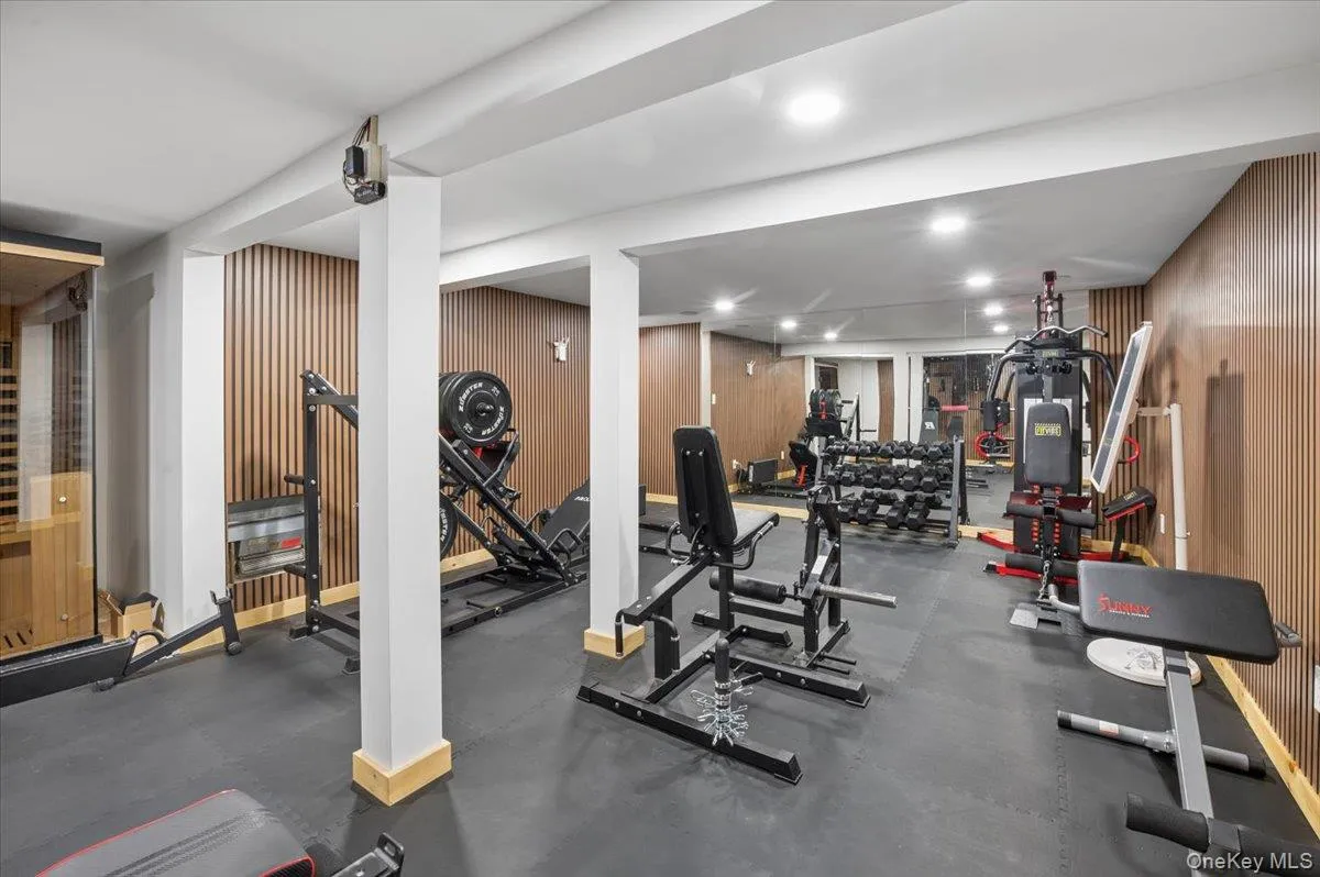 Modern wood-slat accent walls and durable gym flooring.Ample space for your ultimate home gym, yoga studio, or relaxation zone. Modern wood-slat accent walls and durable gym flooring.Ample space for your ultimate home gym, yoga studio, or relaxation zone.