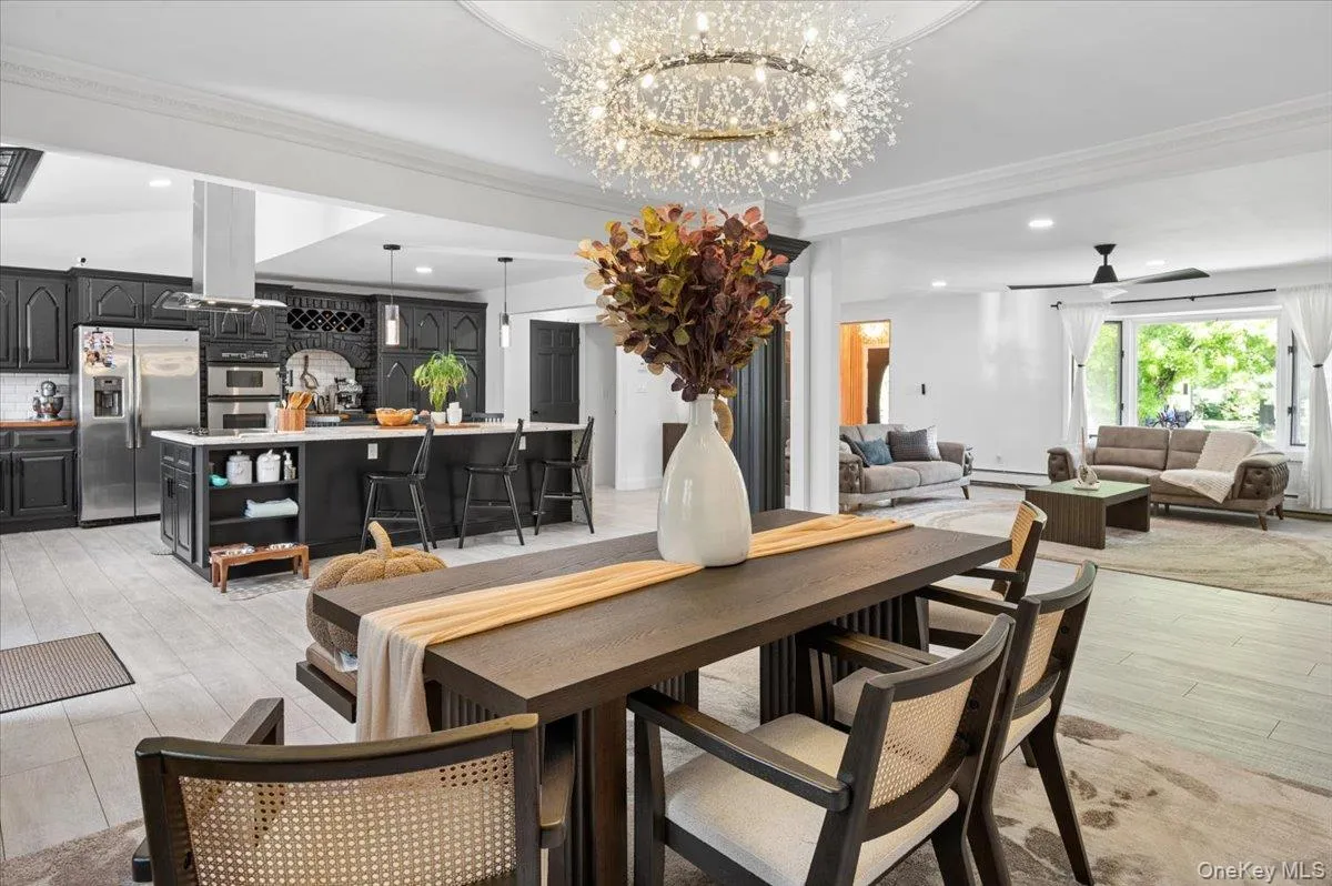 Open-concept living area with light wood-finish flooring. Open-concept living area with light wood-finish flooring.