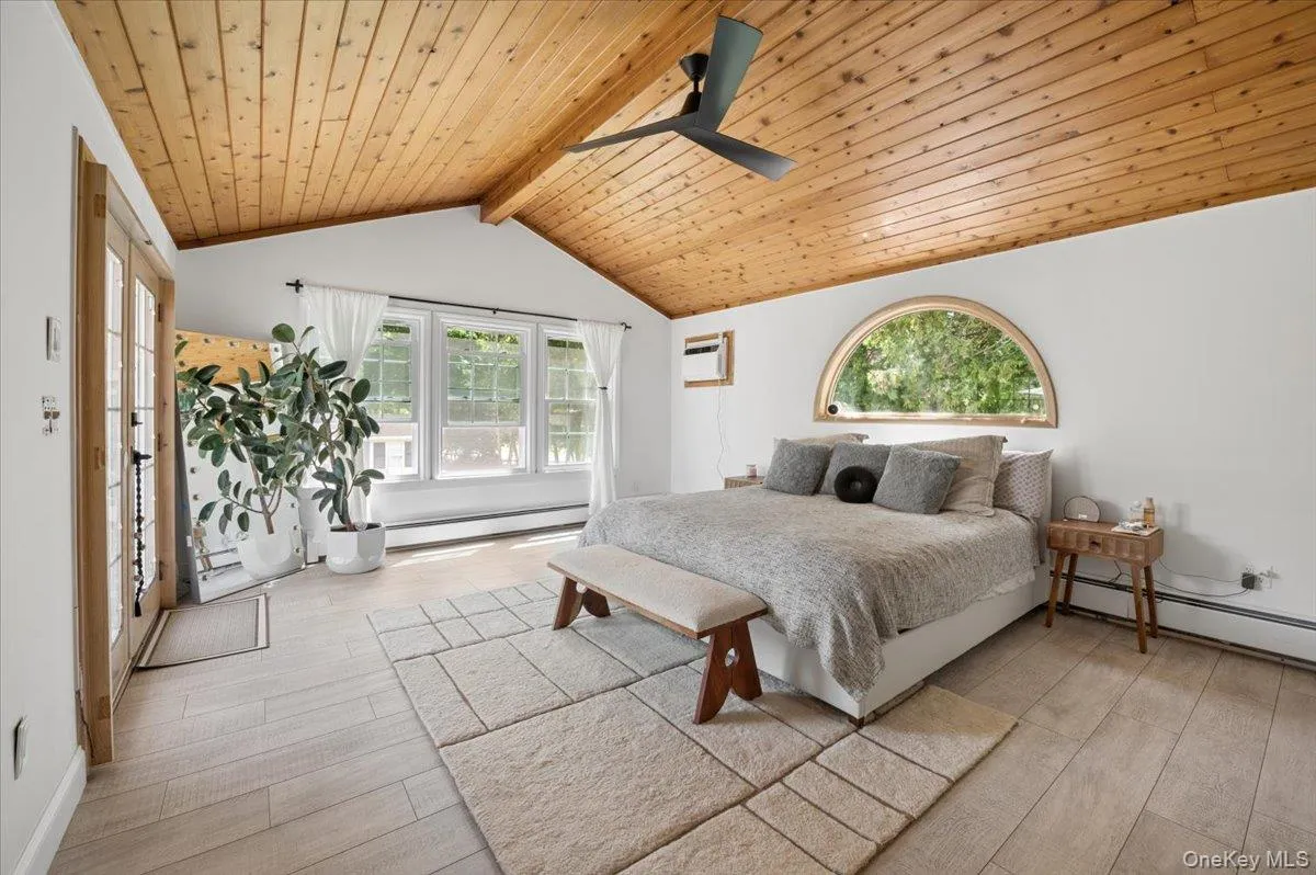Striking Design: Features a dramatic vaulted wood-paneled ceiling and a large arched window that frames the lush outdoor greenery. Striking Design: Features a dramatic vaulted wood-paneled ceiling and a large arched window that frames the lush outdoor greenery.