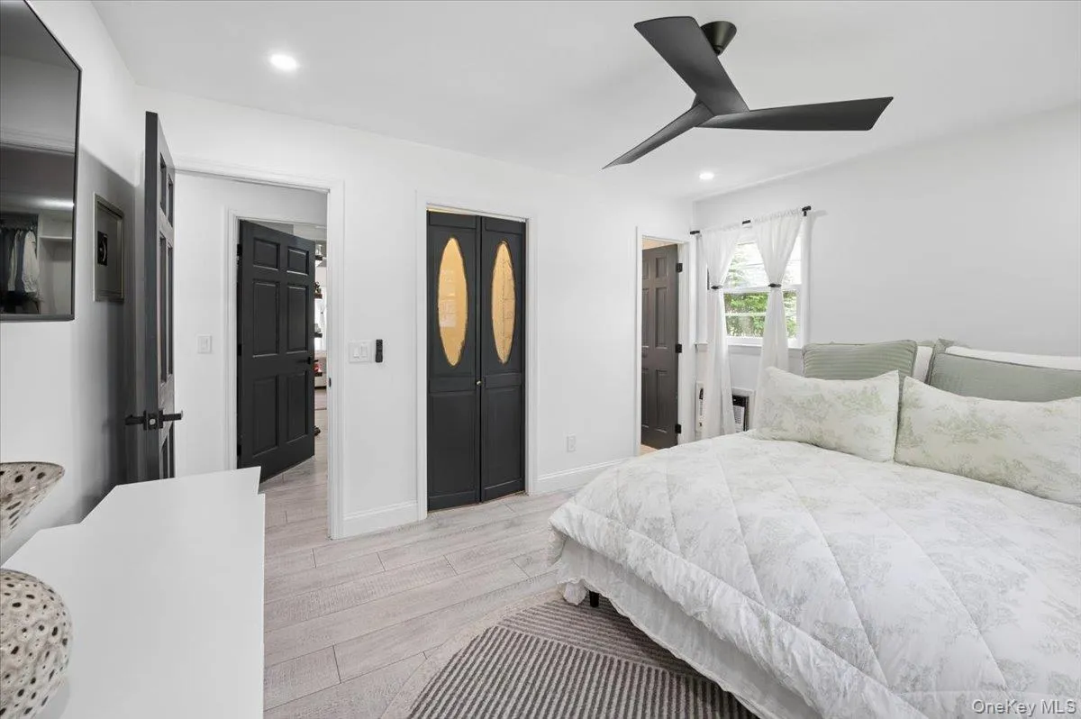 Bright room featuring light wood-finish flooring, recessed lighting, and a modern ceiling fan. Bright room featuring light wood-finish flooring, recessed lighting, and a modern ceiling fan.