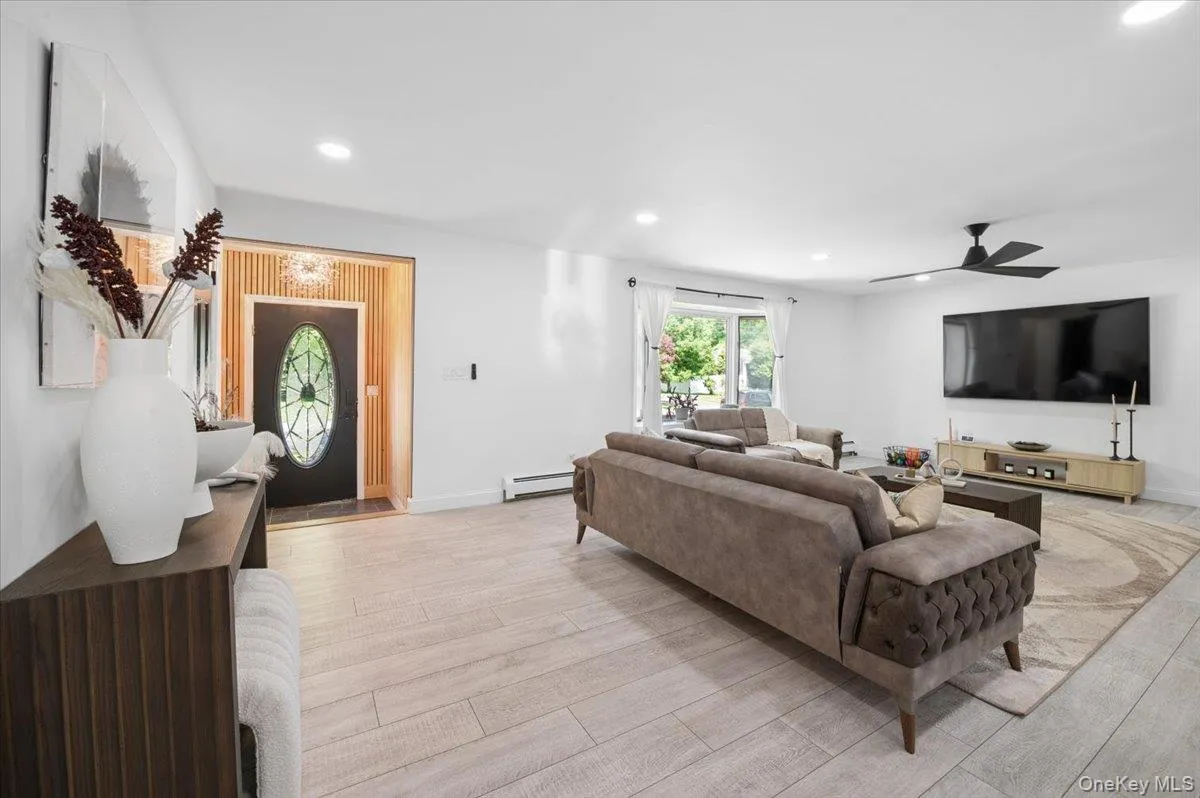 The Heart of the Home, step inside to a breathtaking open-concept living space bathed in natural light from a large bay window. The Heart of the Home, step inside to a breathtaking open-concept living space bathed in natural light from a large bay window.