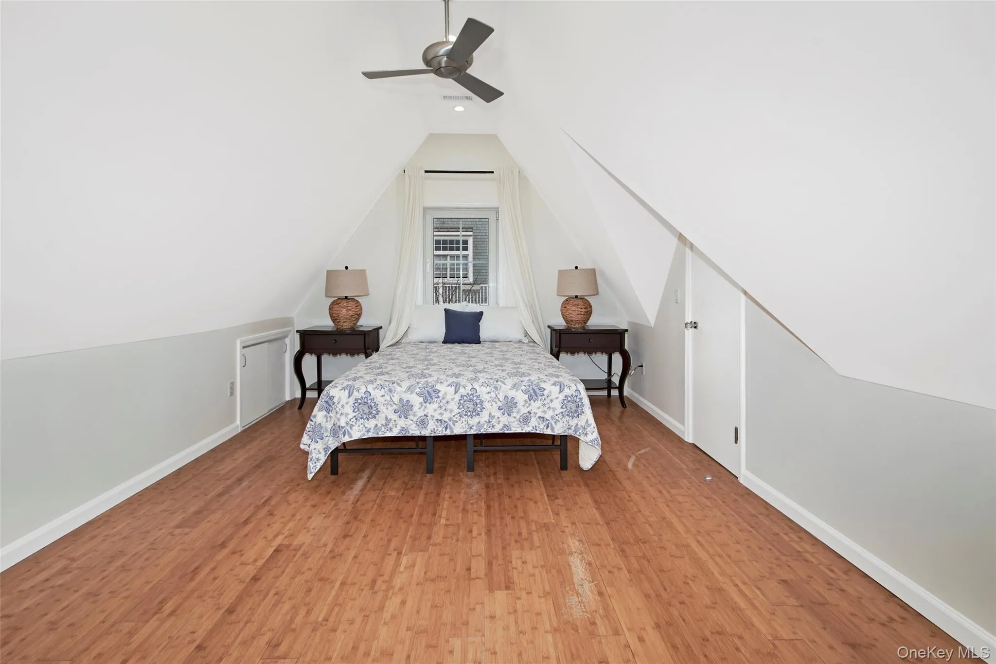 Hardwood flooring, sloped ceiling architecture, recessed lighting, ceiling fan, and built-in storage access Hardwood flooring, sloped ceiling architecture, recessed lighting, ceiling fan, and built-in storage access