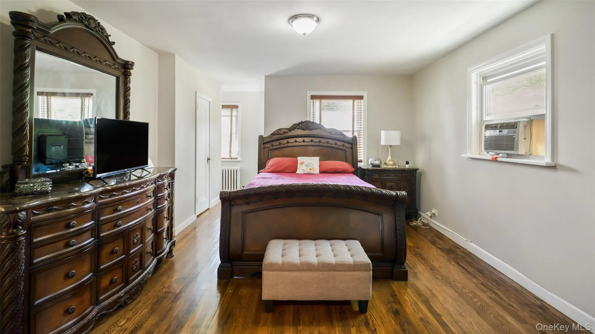 Hardwood flooring complements light gray walls throughout this room Hardwood flooring complements light gray walls throughout this room
