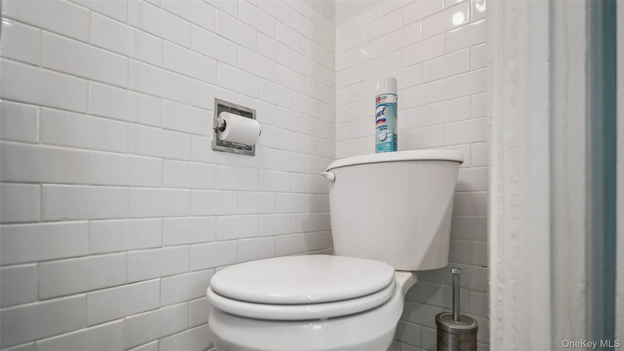White subway tile walls with a recessed toilet paper holder White subway tile walls with a recessed toilet paper holder
