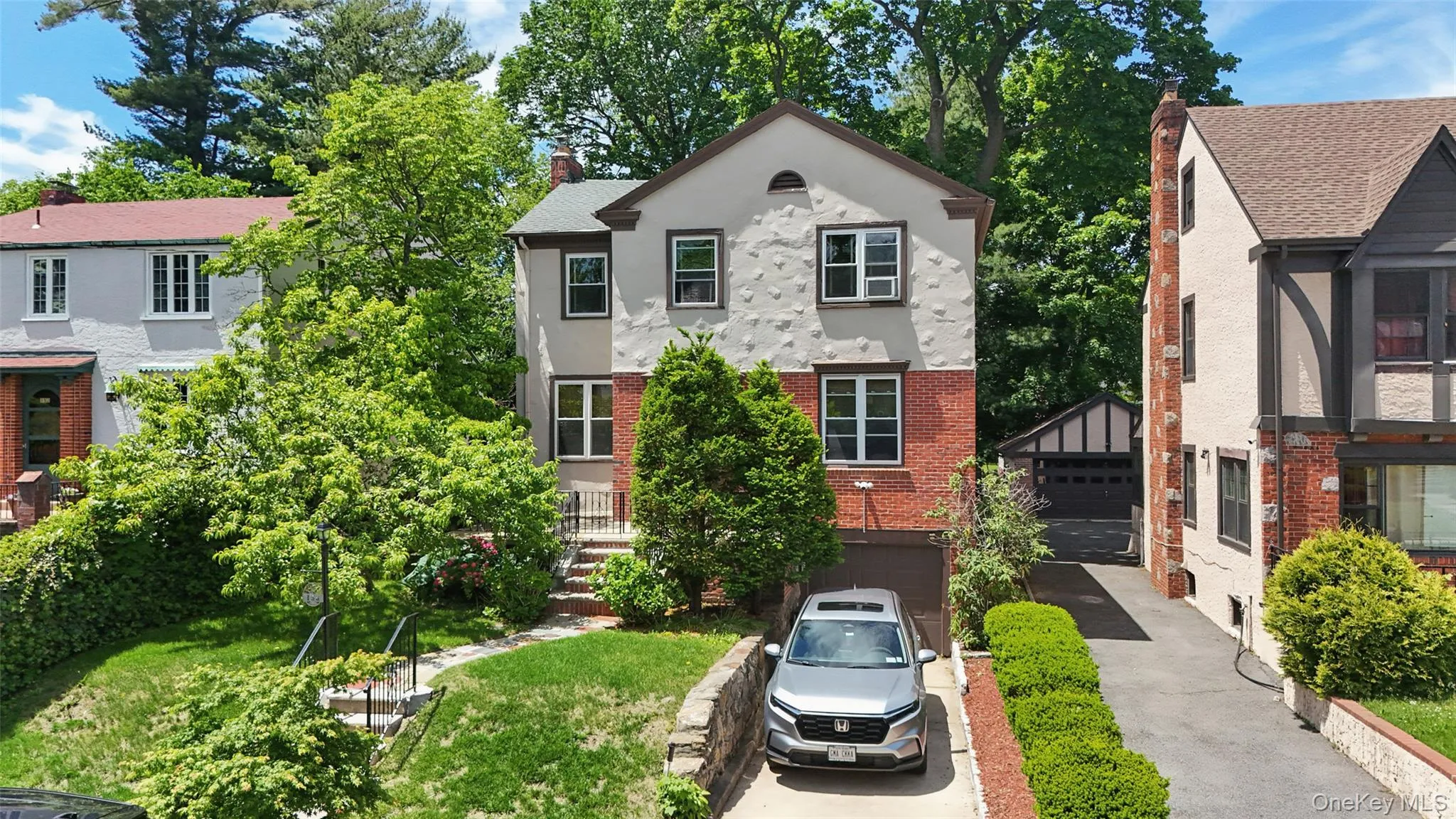 Two-story residence featuring a stucco and brick facade Two-story residence featuring a stucco and brick facade