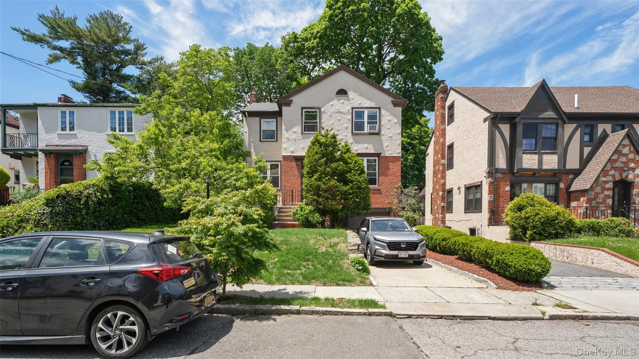 Two-story residence featuring a brick first level and stucco upper level Two-story residence featuring a brick first level and stucco upper level