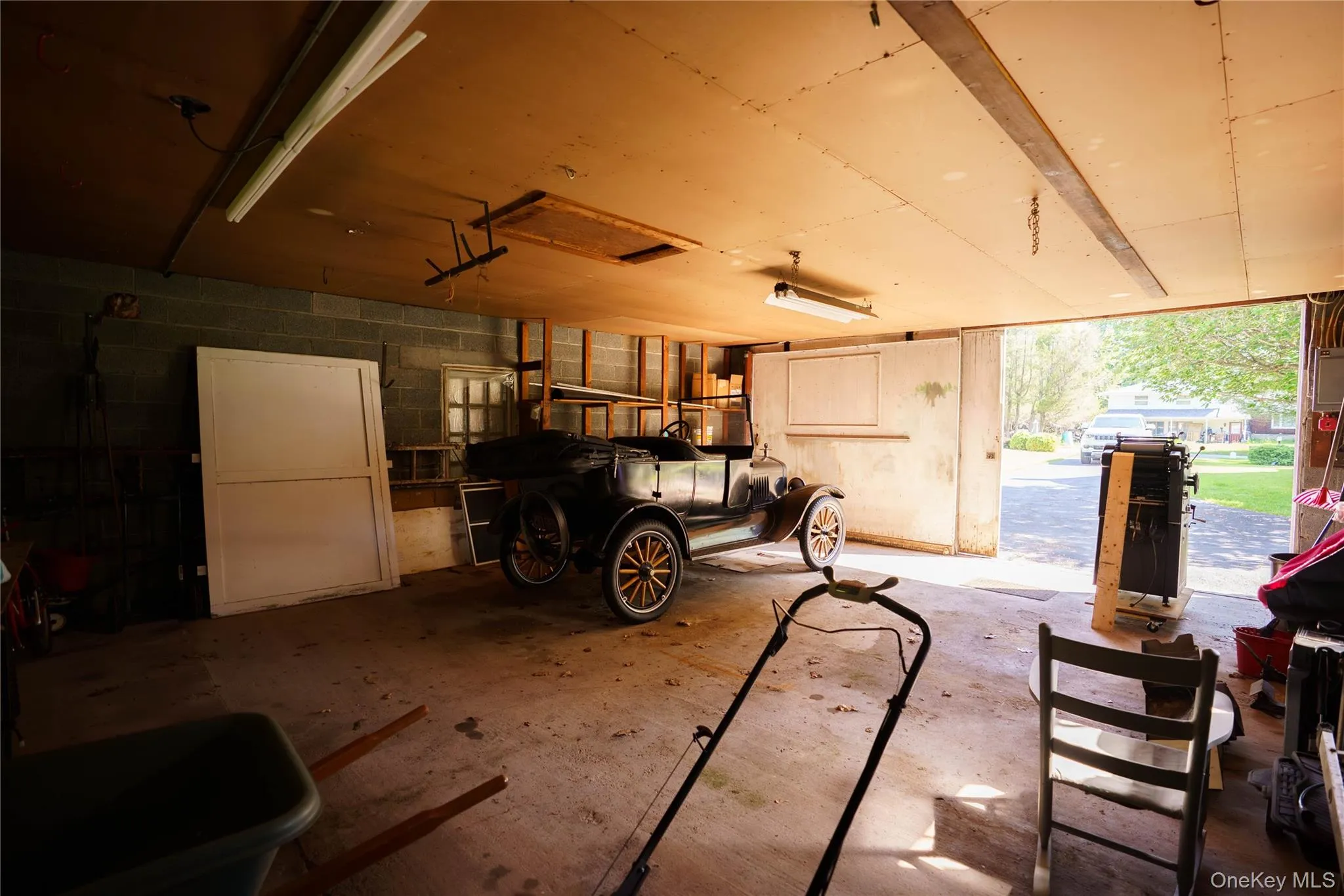 Concrete block wall construction with exposed ceiling joists and fluorescent overhead lighting Concrete block wall construction with exposed ceiling joists and fluorescent overhead lighting