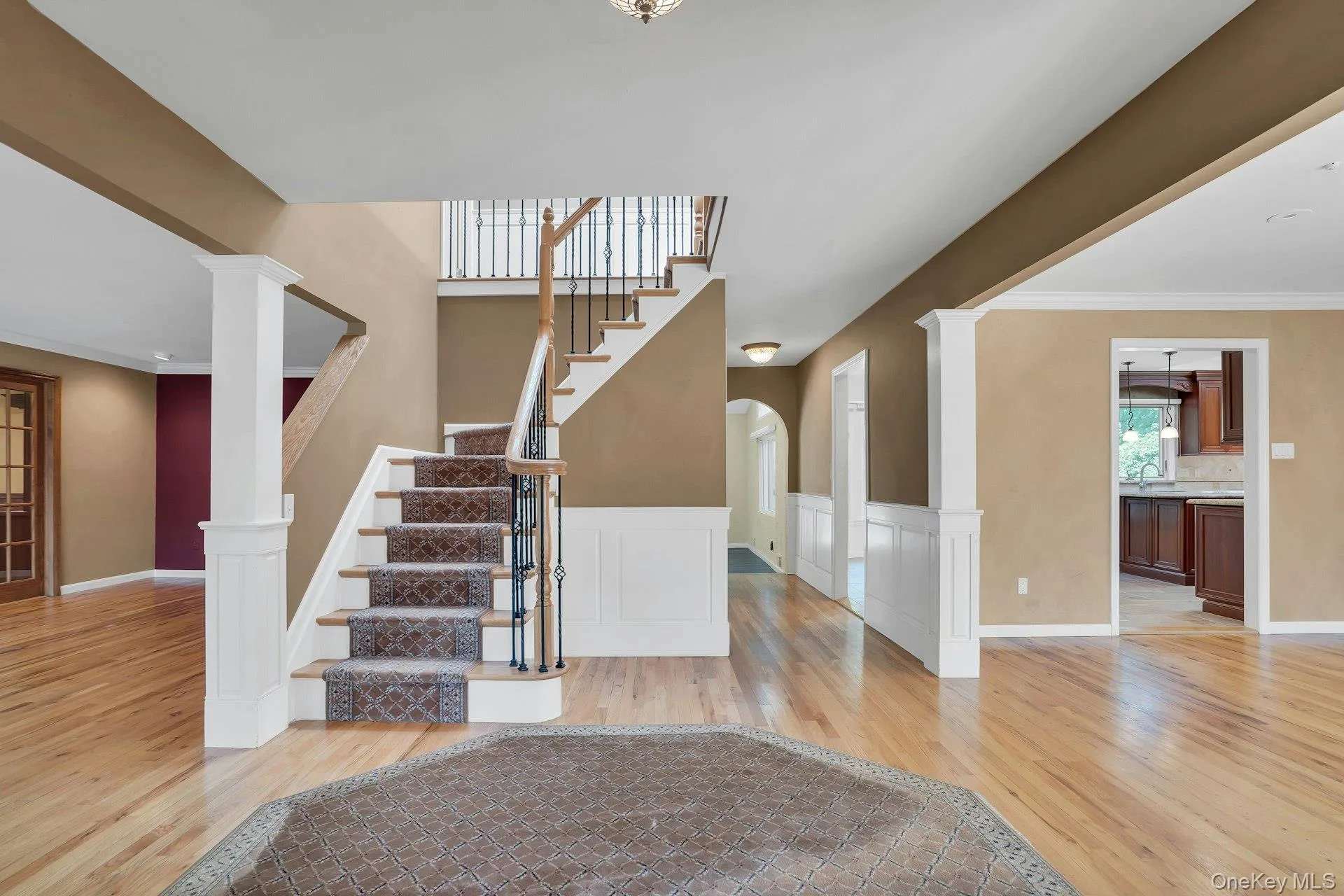 Large entry foyer with hardwood floors and bridal staircase. Large entry foyer with hardwood floors and bridal staircase.