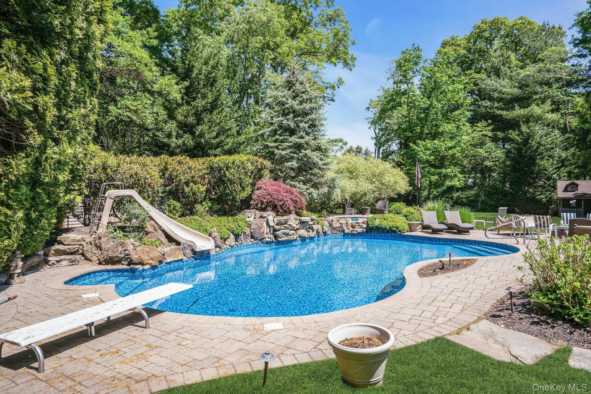 In-Ground Pool with slide and diving board. In-Ground Pool with slide and diving board.