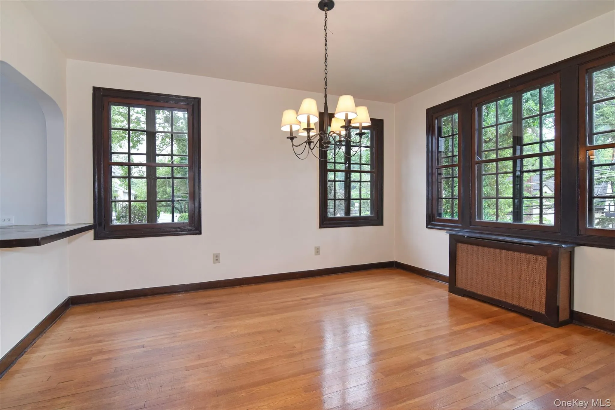 Formal dining room with large windows and chandelier Formal dining room with large windows and chandelier