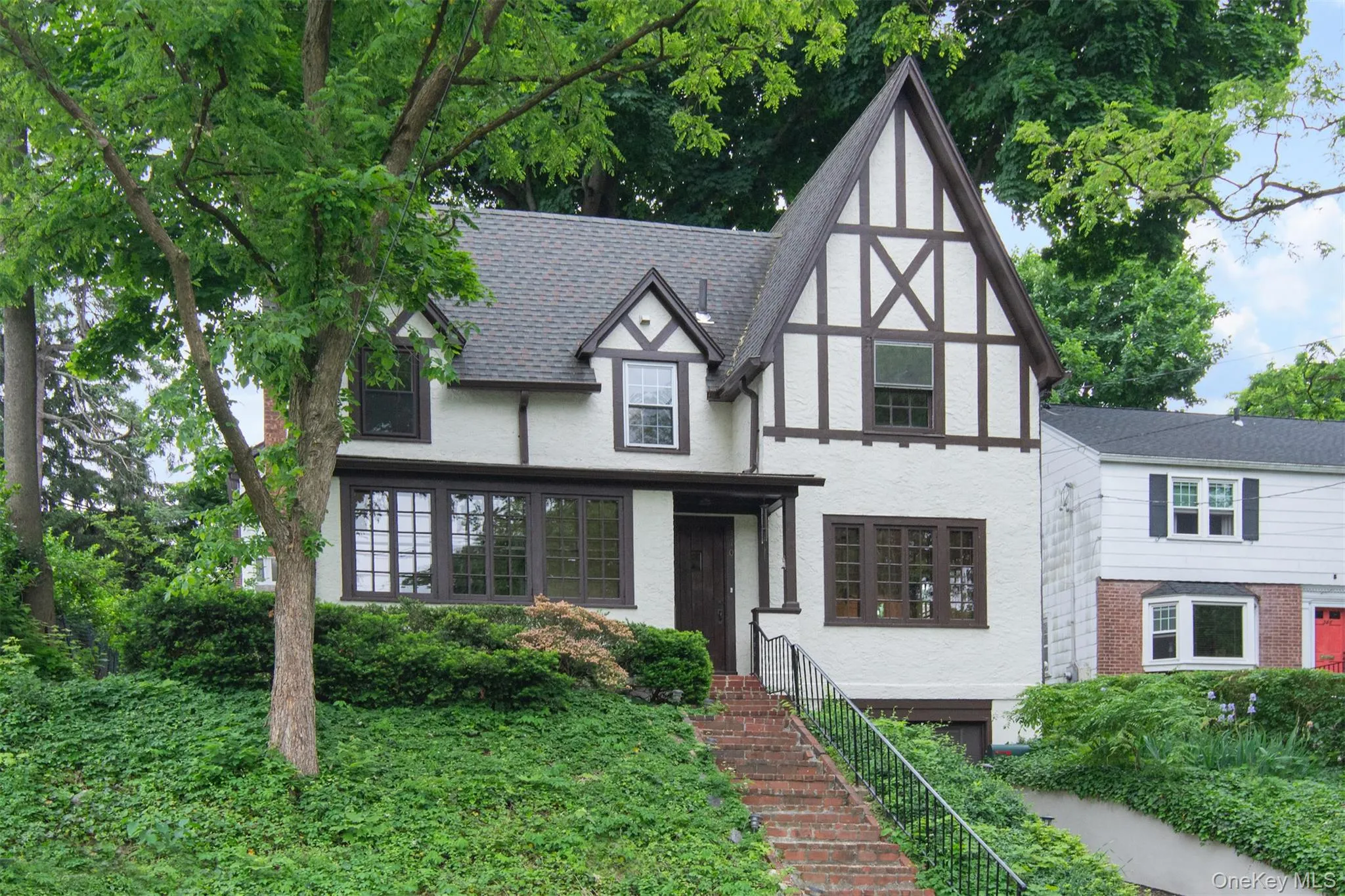 Tudor Revival exterior featuring half-timber detailing and a pitched roof Tudor Revival exterior featuring half-timber detailing and a pitched roof