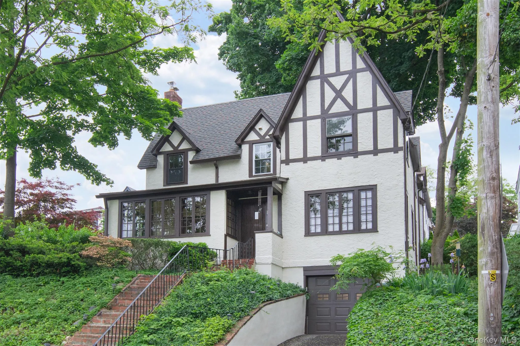 Tudor-style residence featuring white stucco and dark timber framing Tudor-style residence featuring white stucco and dark timber framing