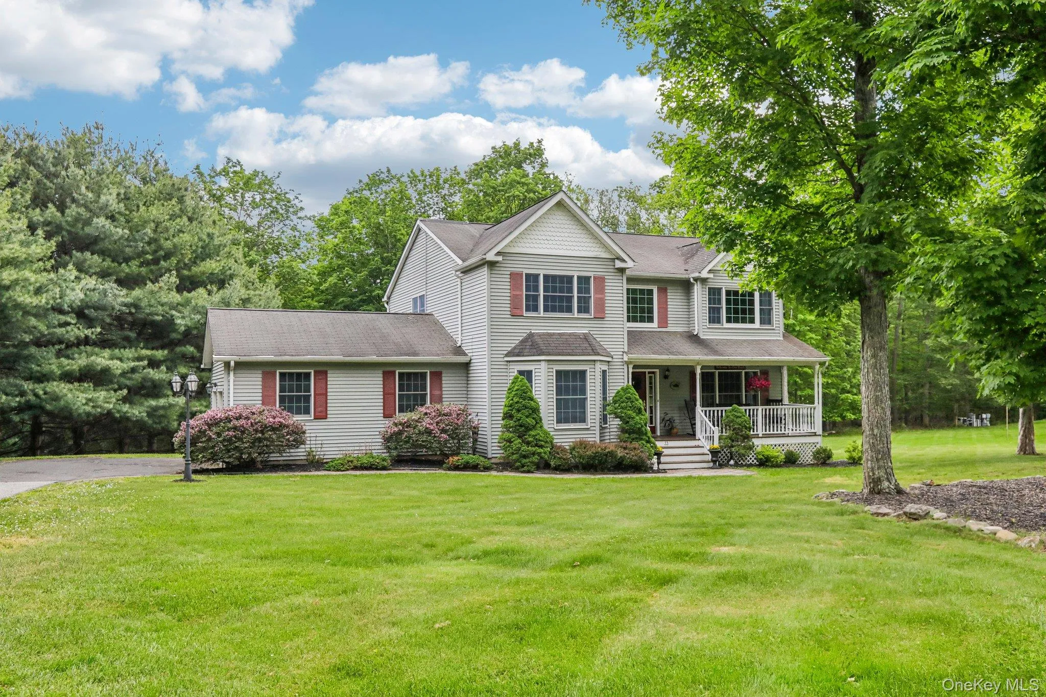 Inviting Colonial home with front porch. Inviting Colonial home with front porch.