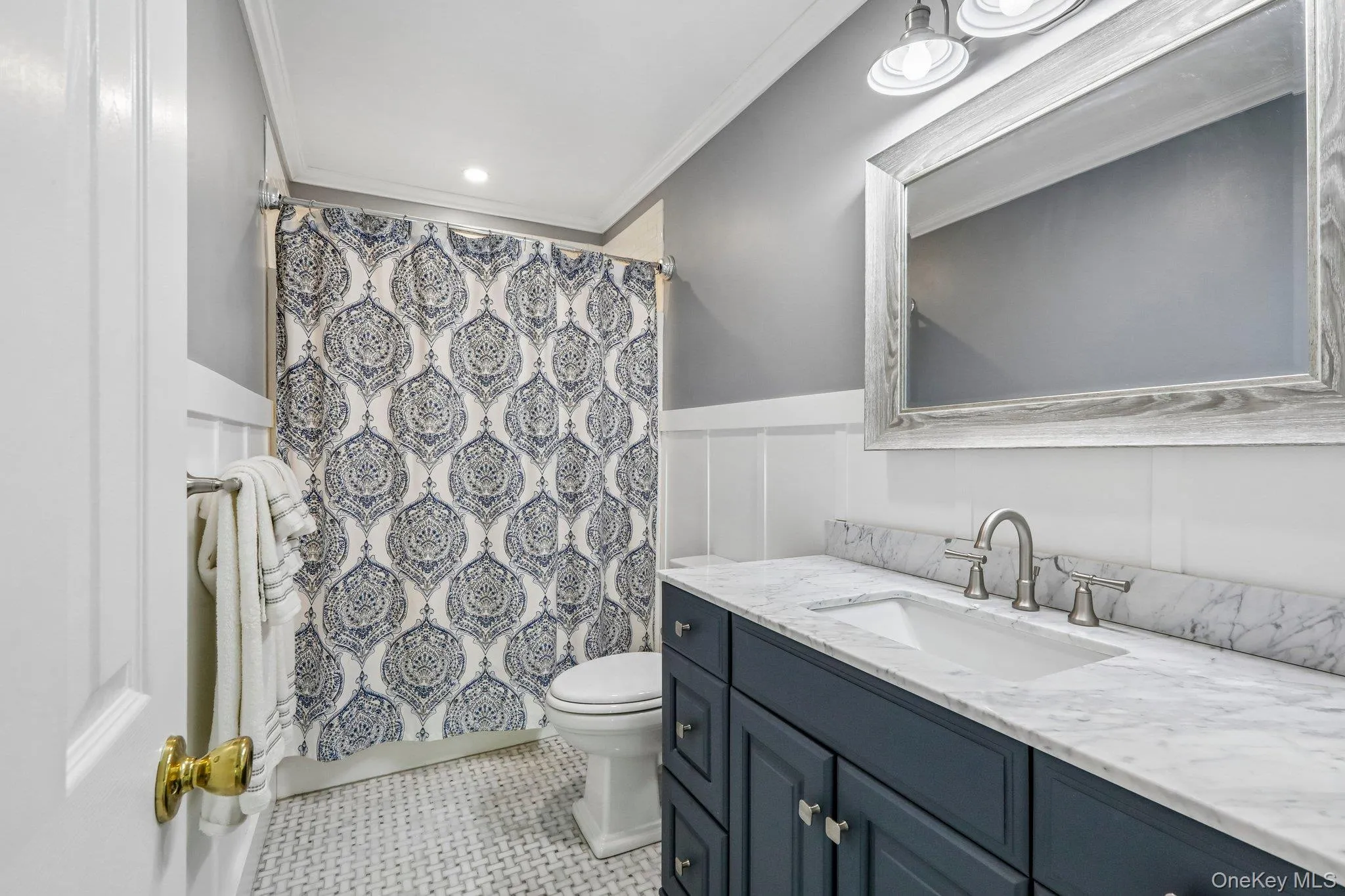 Well appointed shared hall bathroom with marble countertop. Well appointed shared hall bathroom with marble countertop.