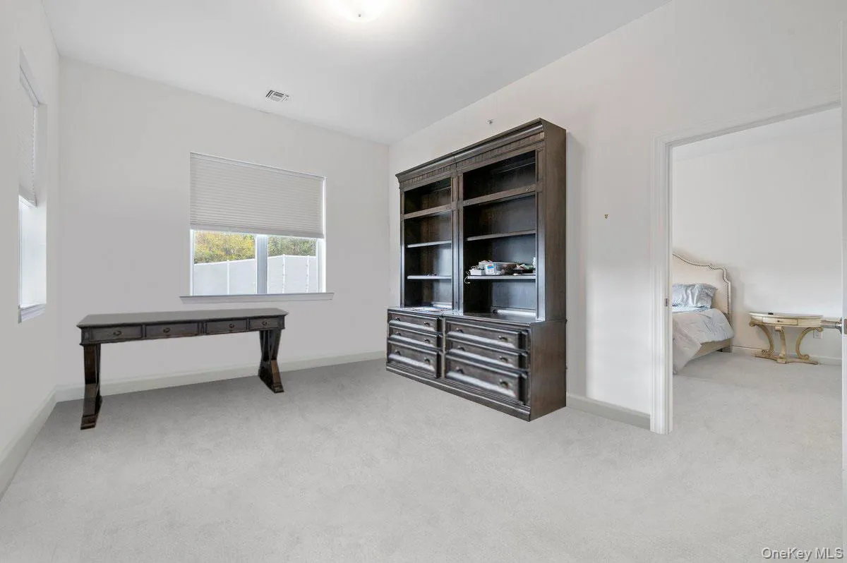 Unfurnished office featuringlight carpet and baseboards Unfurnished office featuringlight carpet and baseboards