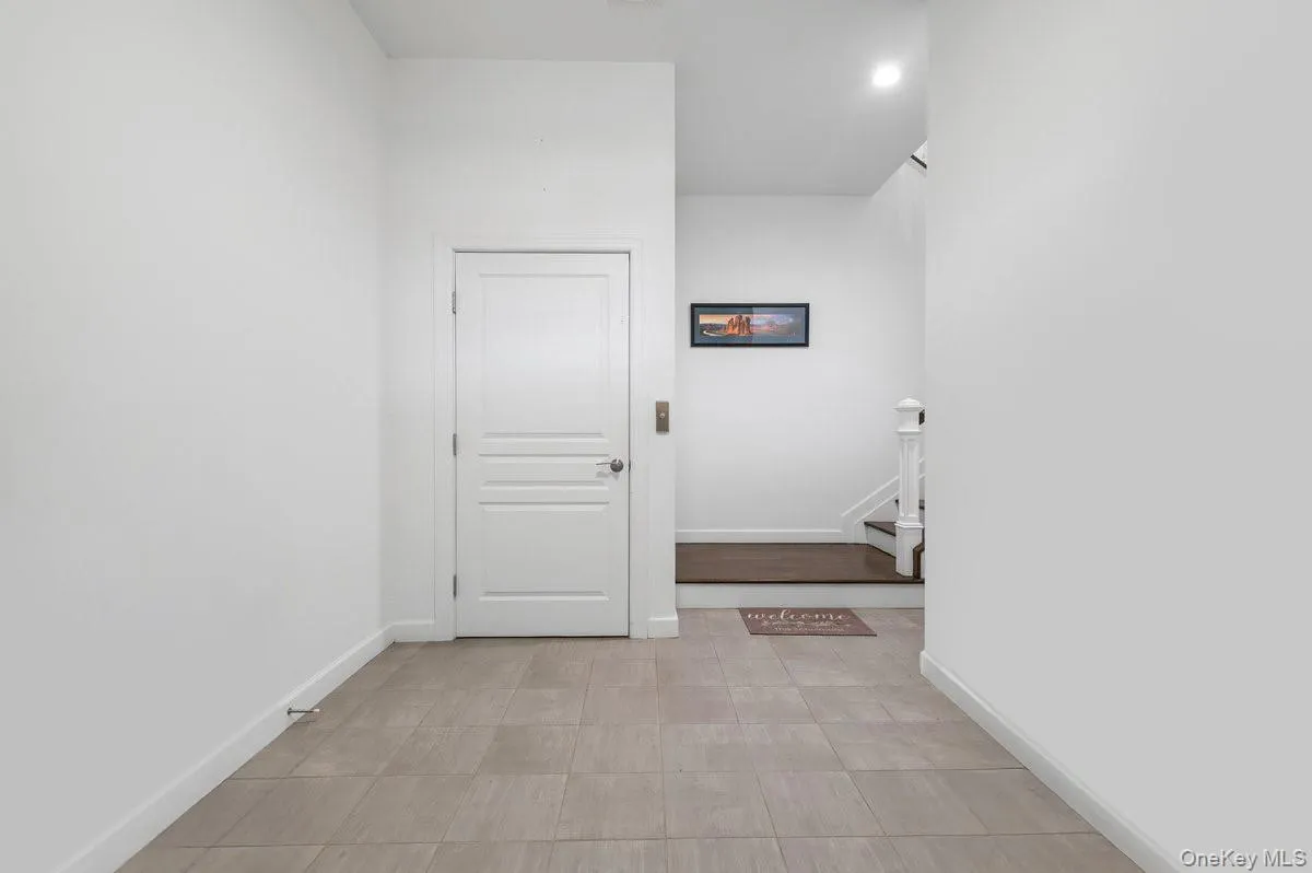 Hall with baseboards and stairway Hall with baseboards and stairway